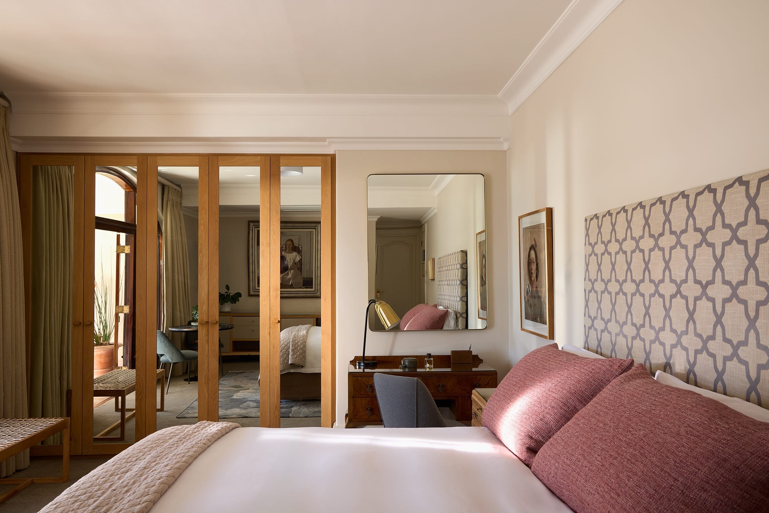 Deluxe House Room bed dressed in soft layered linens
