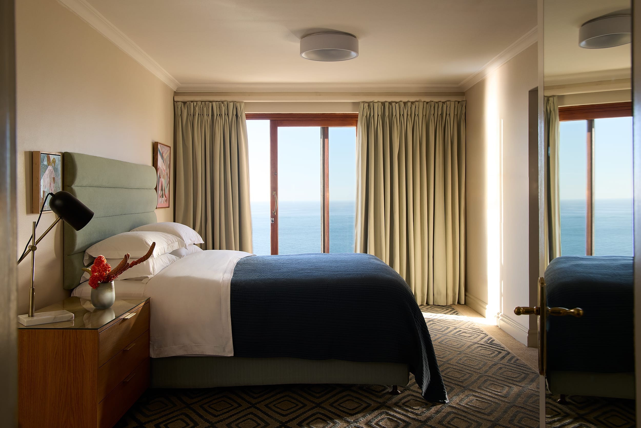 The suite bedroom framed by soft natural light