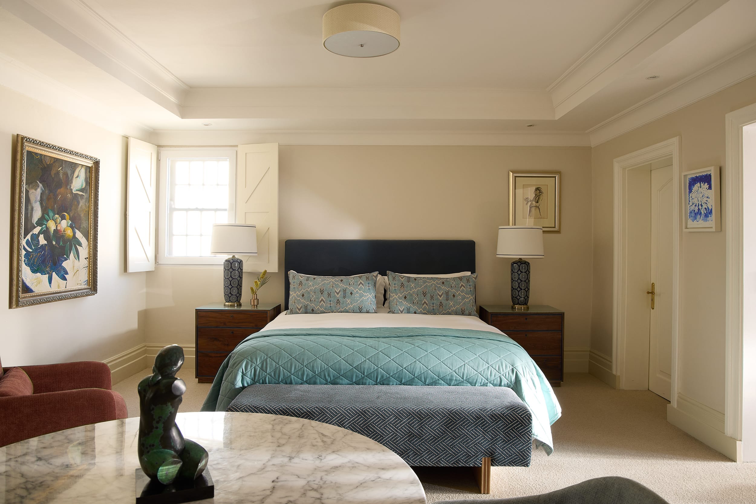 Deluxe House Room bed dressed in soft layered linens