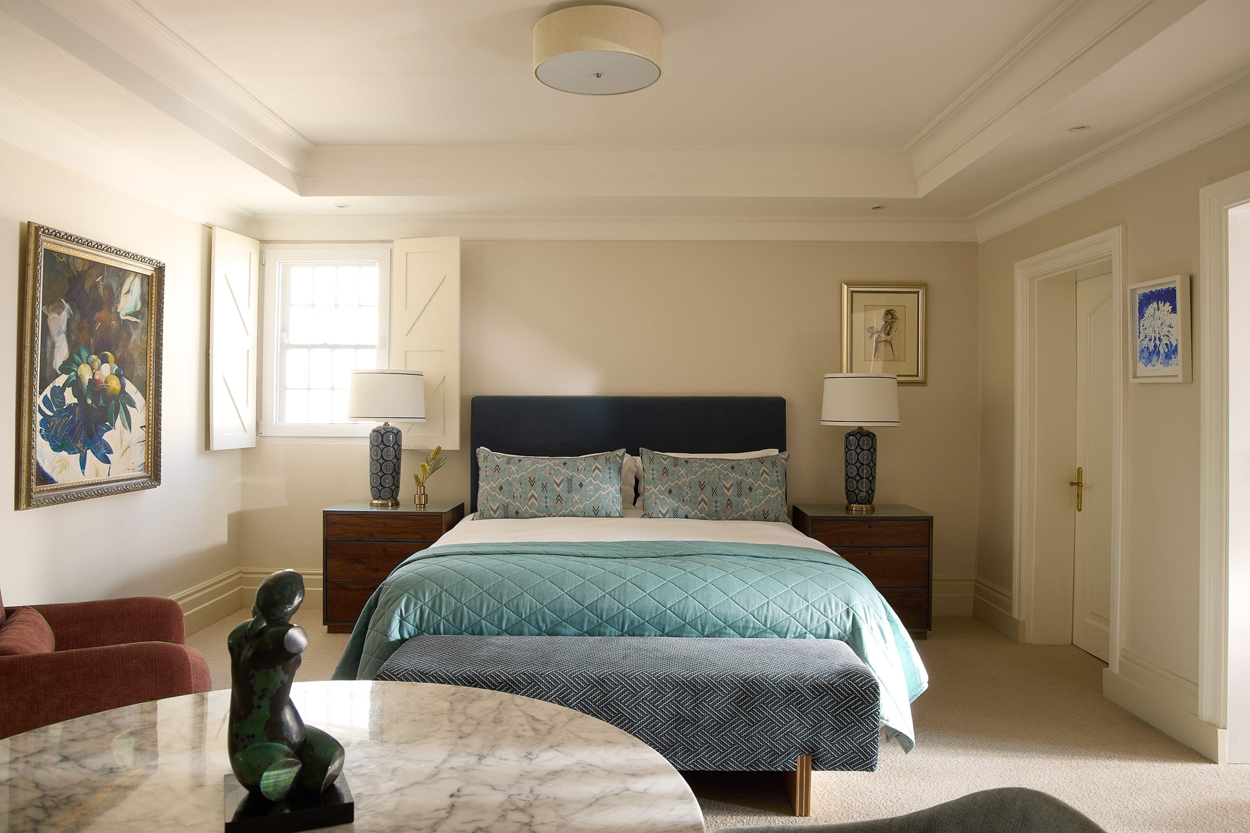 Deluxe House Room bed dressed in soft layered linens