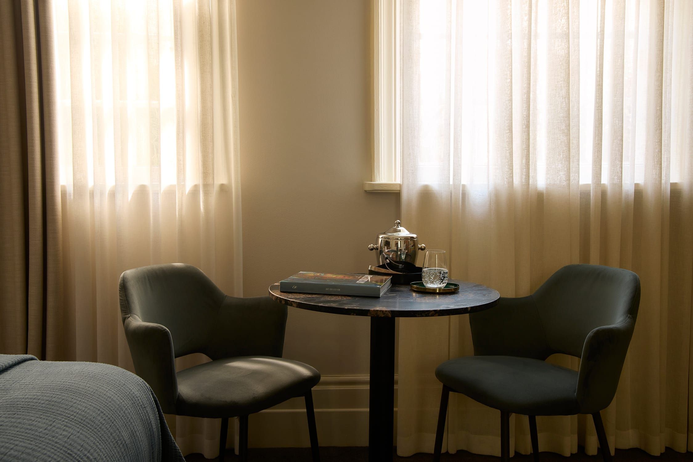 Soft morning light across the bed and muted interior tones