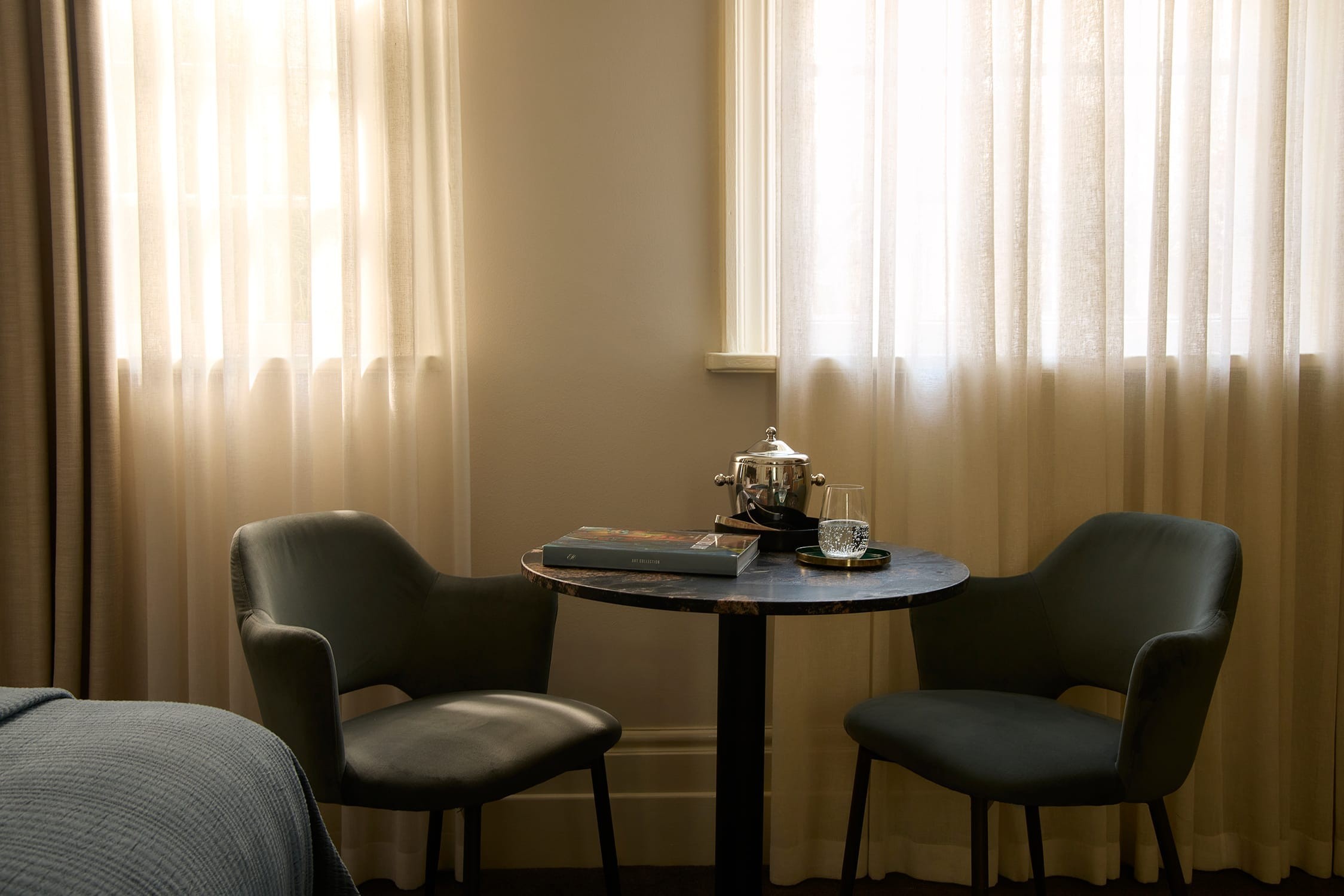 Soft morning light across the bed and muted interior tones
