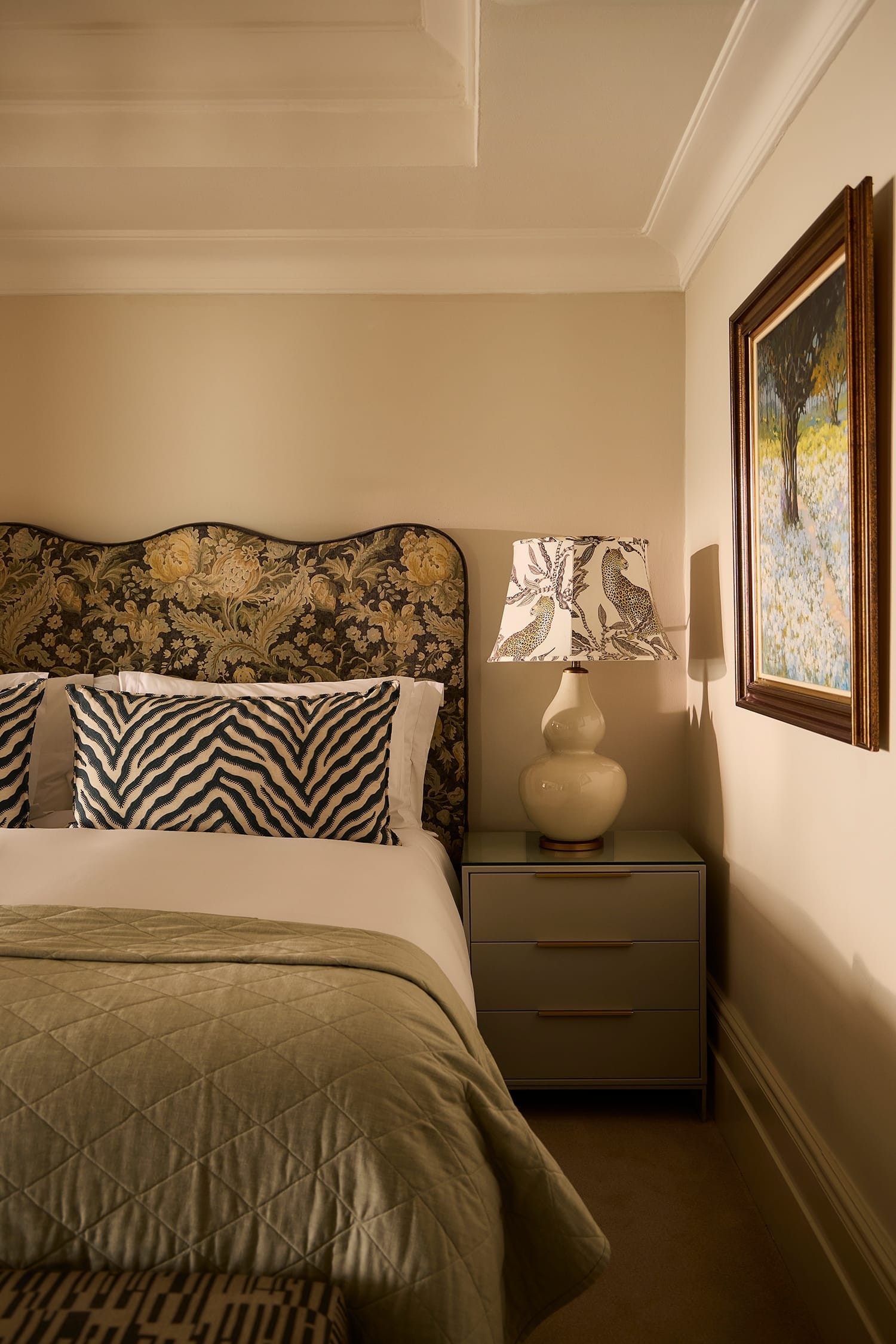 Deluxe House Room bed dressed in soft layered linens