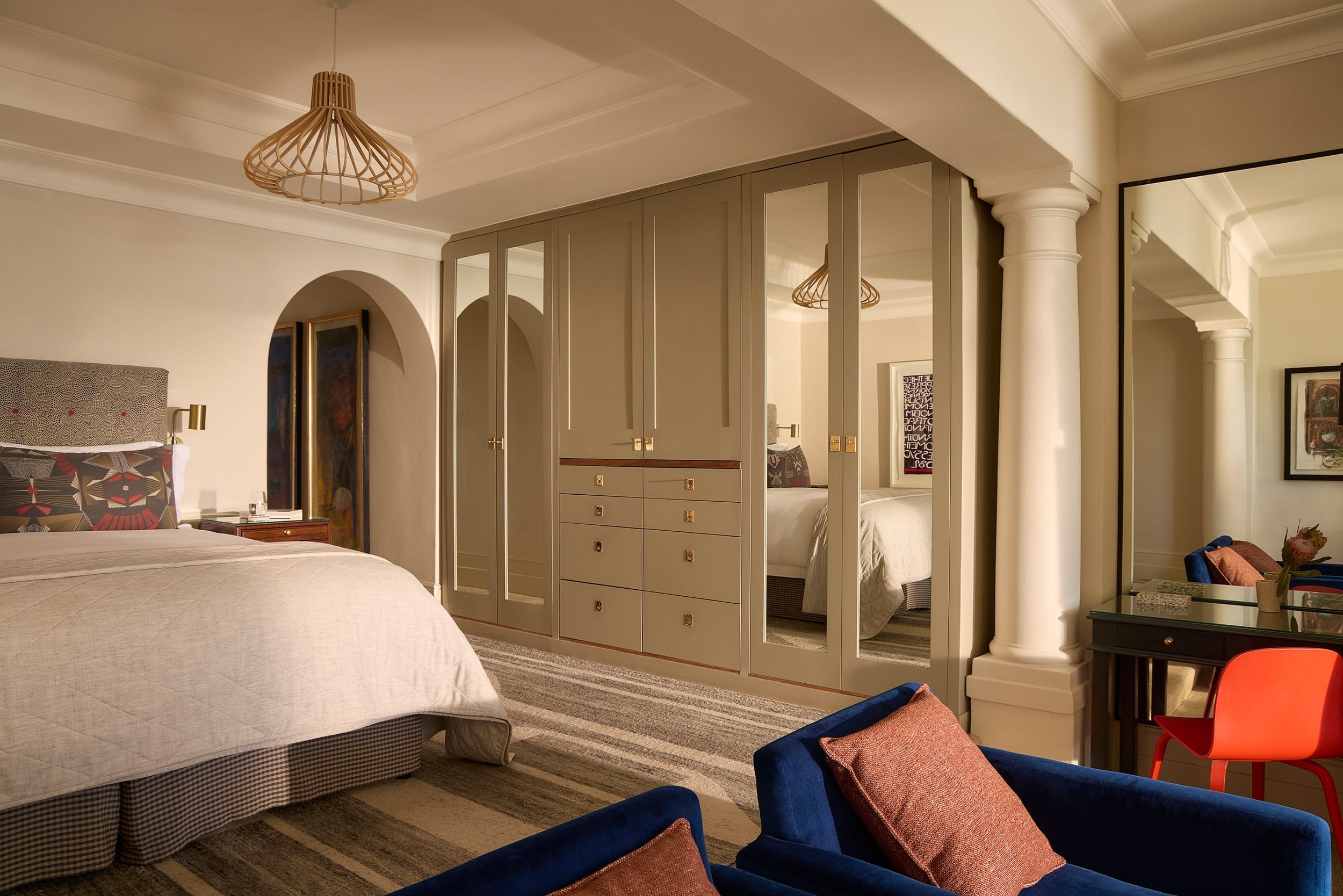 The bed framed by soft natural light in the Deluxe House Room