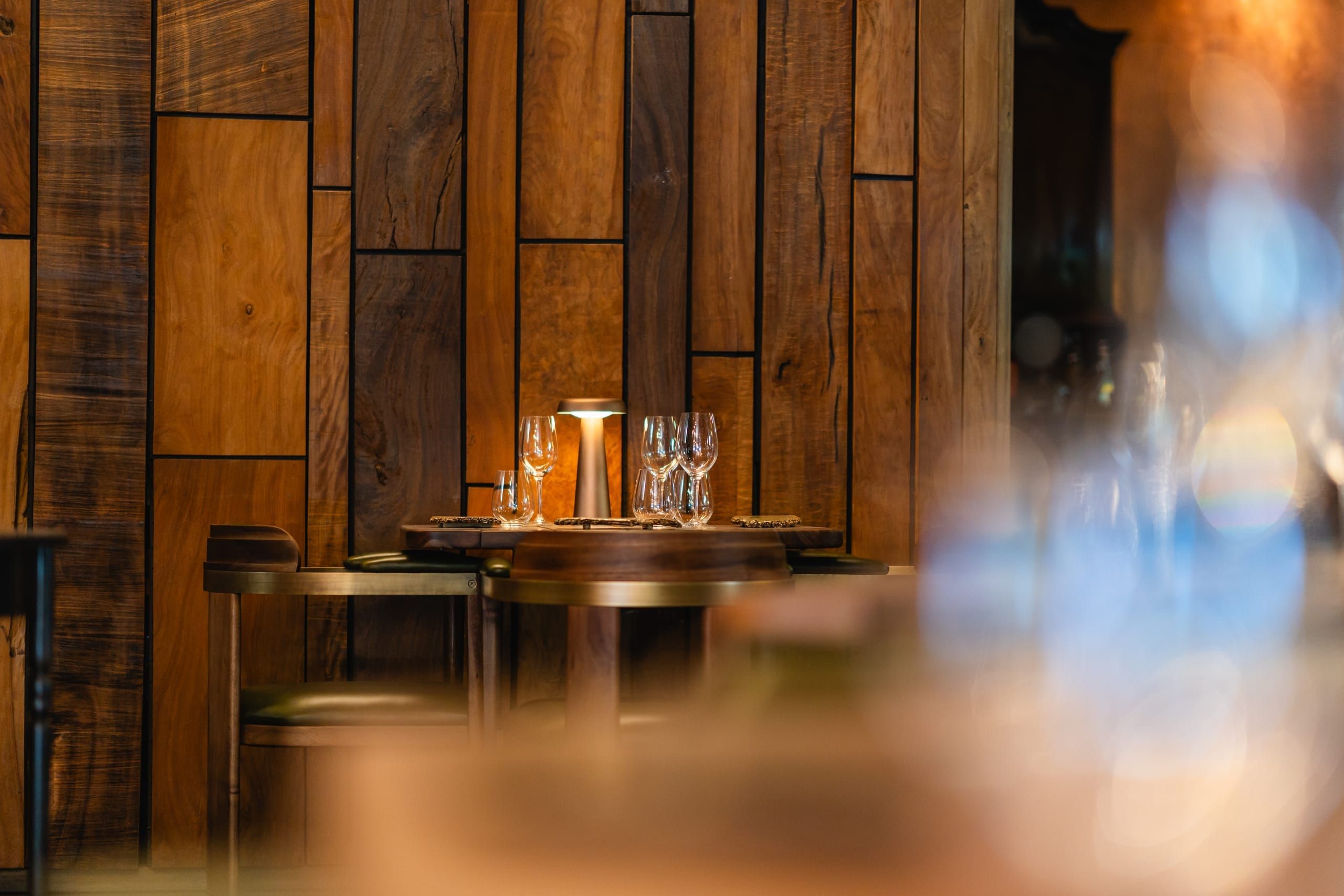 A quiet timber-panelled corner of the Wine Gallery set with glasses
