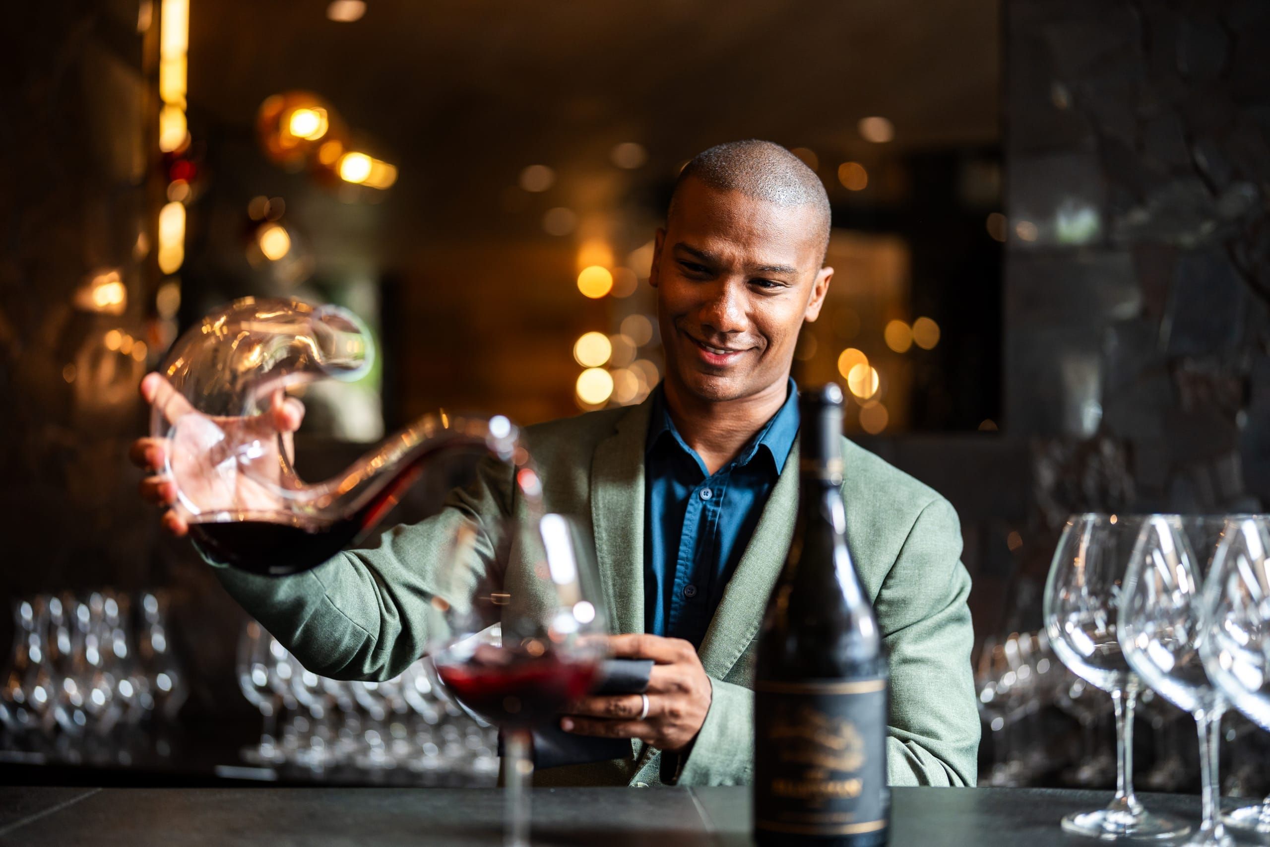 A sommelier decanting a South African red wine at the tasting bar