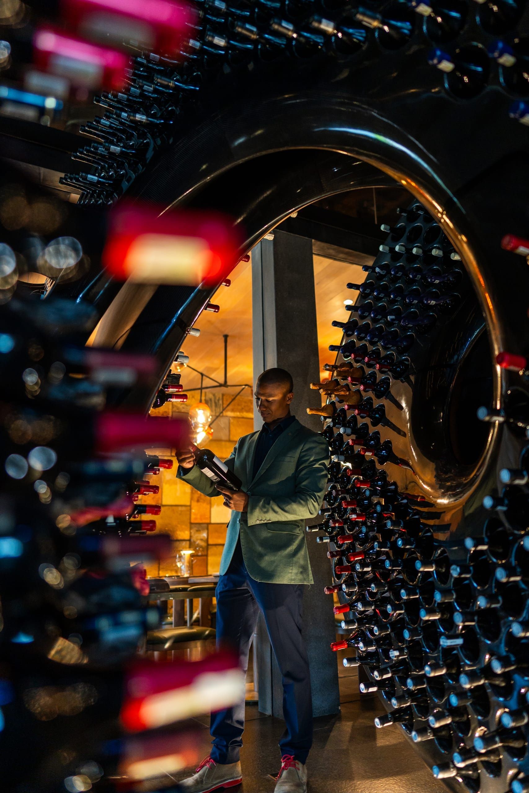 A sommelier selecting a bottle within the spiralling wine racks