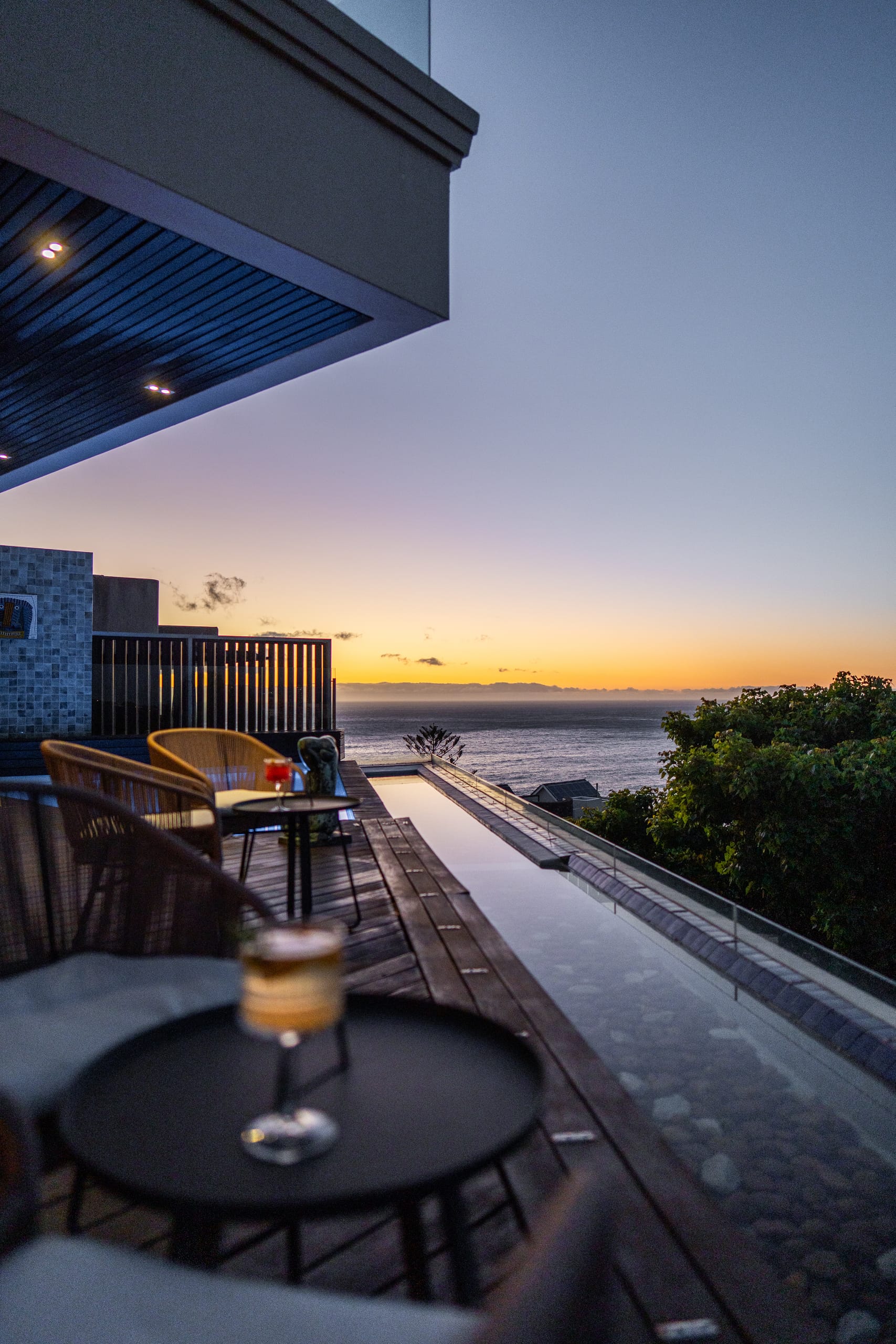 A fireside terrace at dusk above the Atlantic