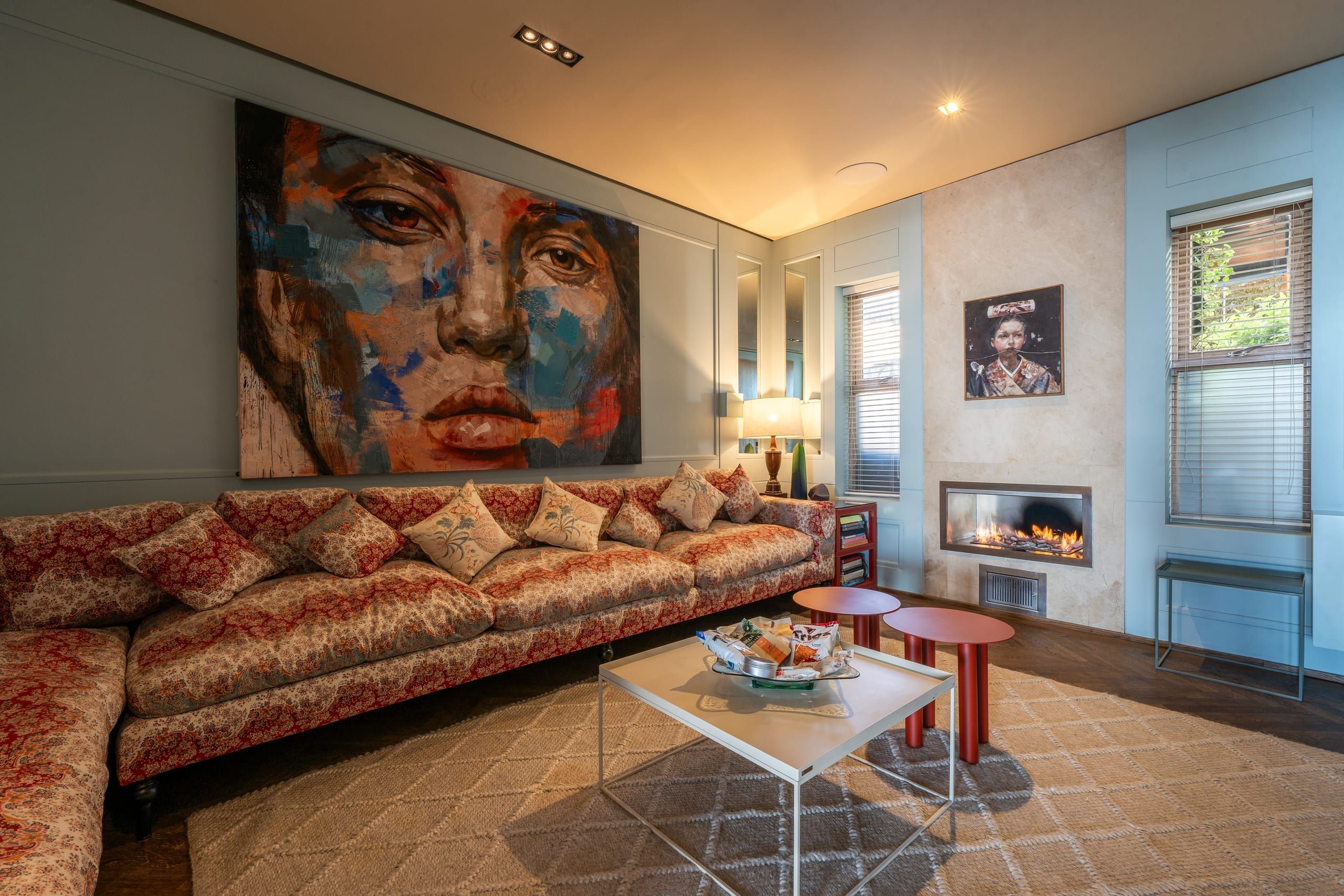 A large painted portrait above a patterned sofa in a sitting room at Ellerman House