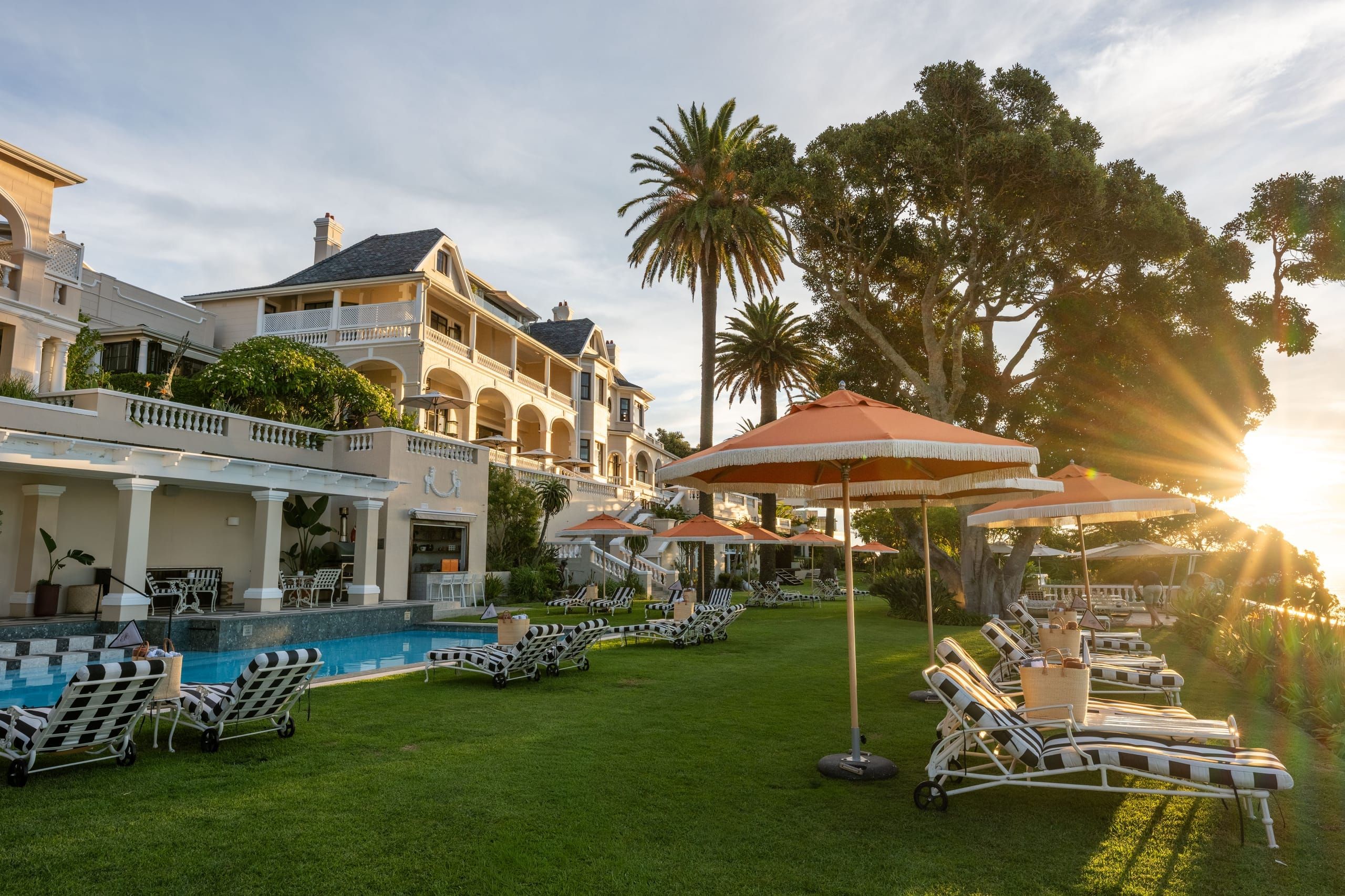 Ellerman House, its lawns and loungers in the golden light of late afternoon