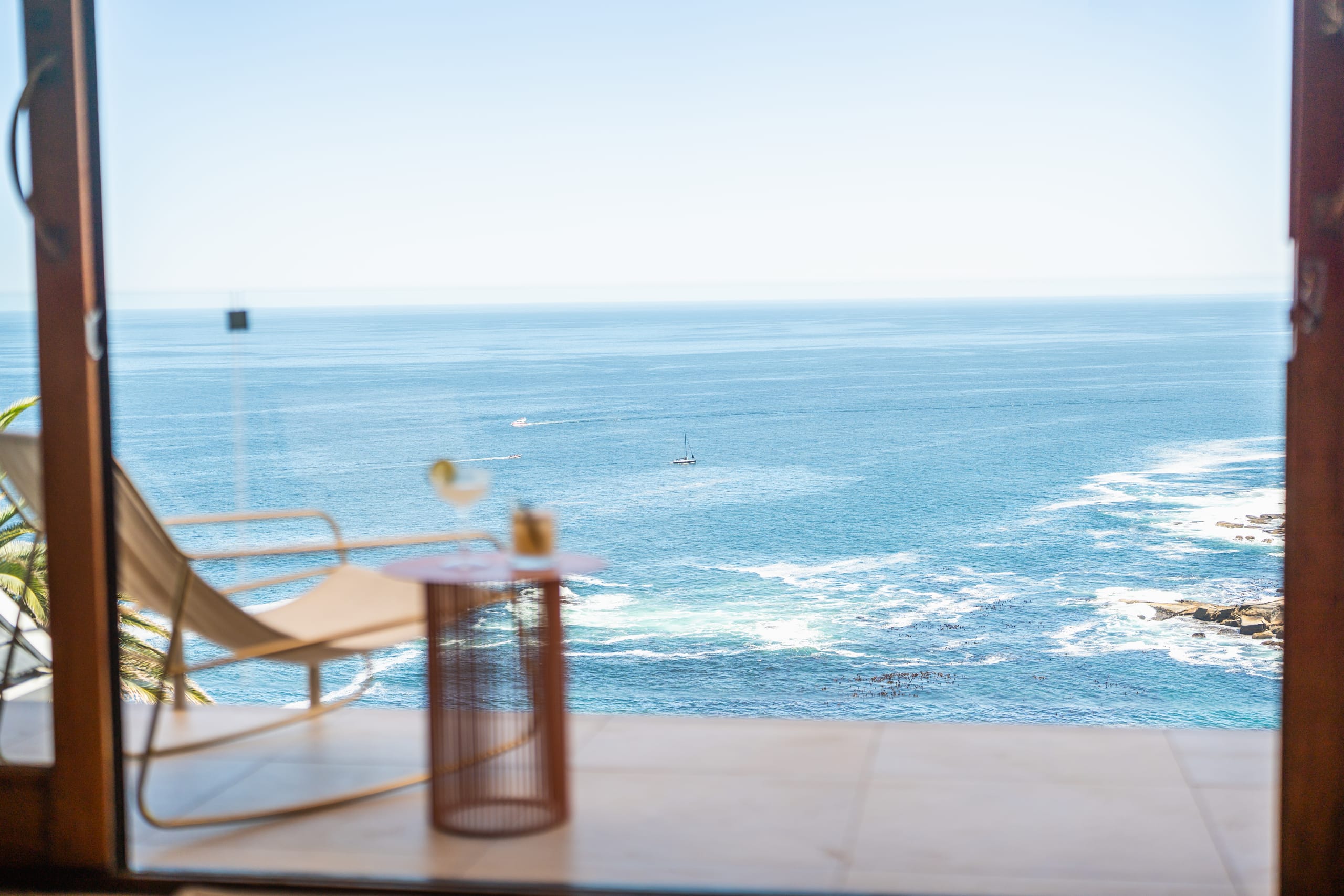 A calm Atlantic horizon framed from a shaded terrace