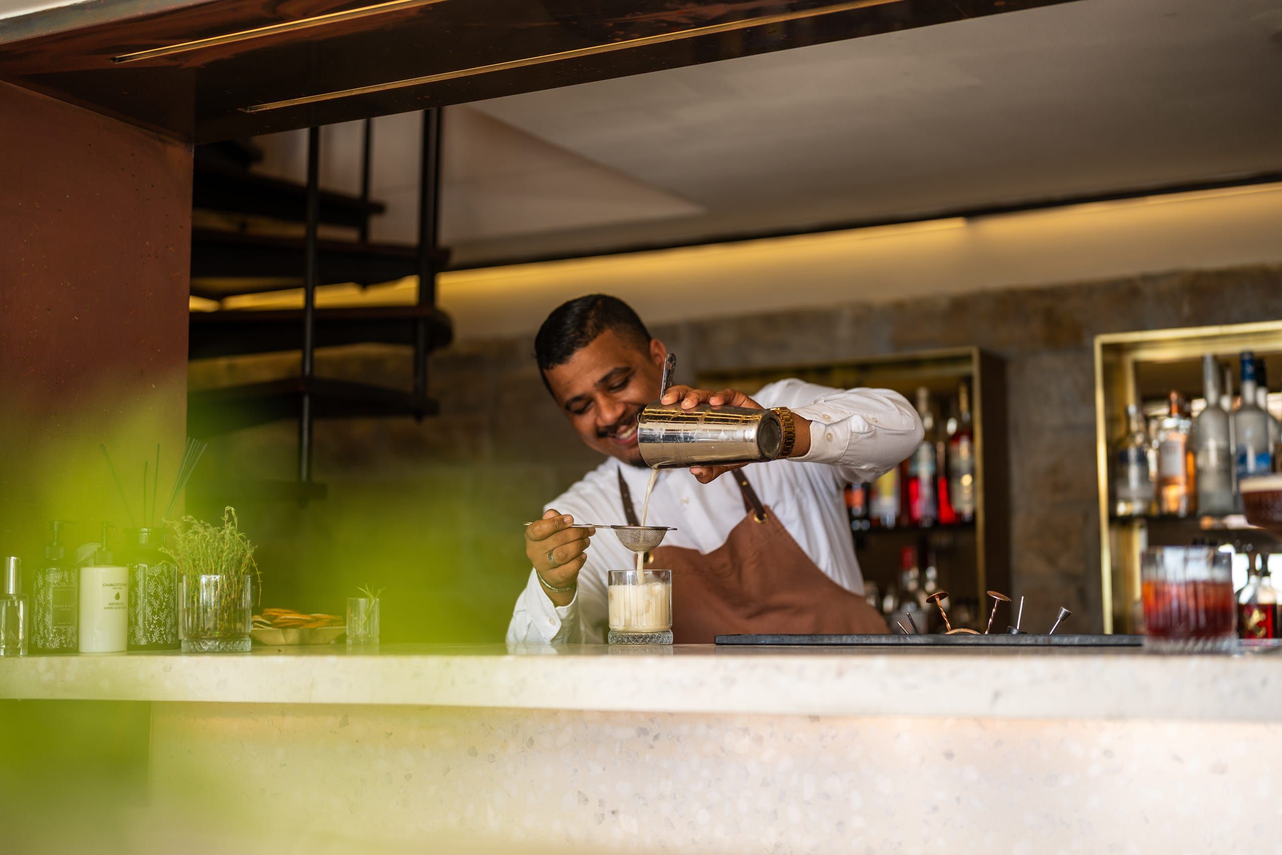 A bartender crafting a cocktail at Bar Roc