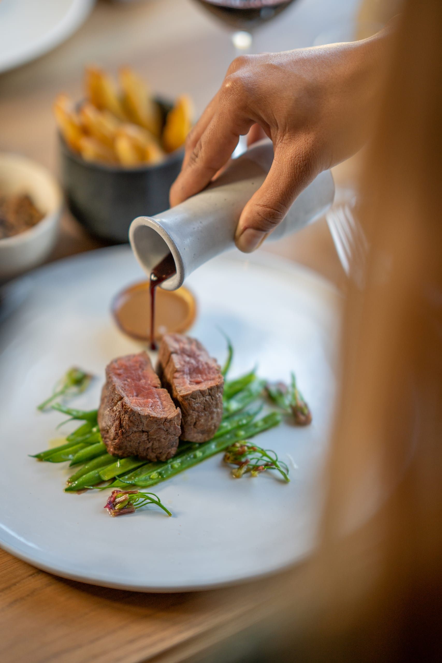 A refined fine-dining plate set against a dark table