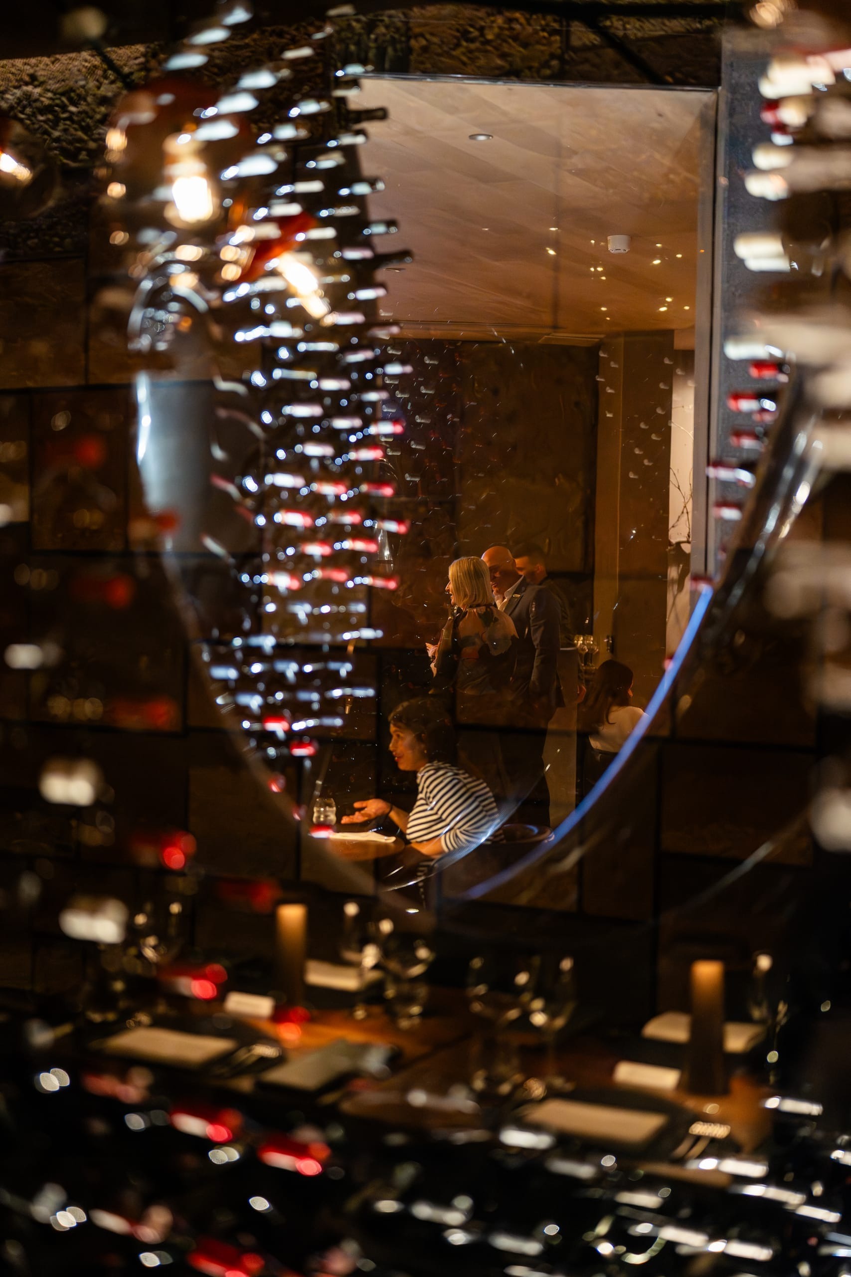 A wine tasting event with glasses and bottles arranged across a long table