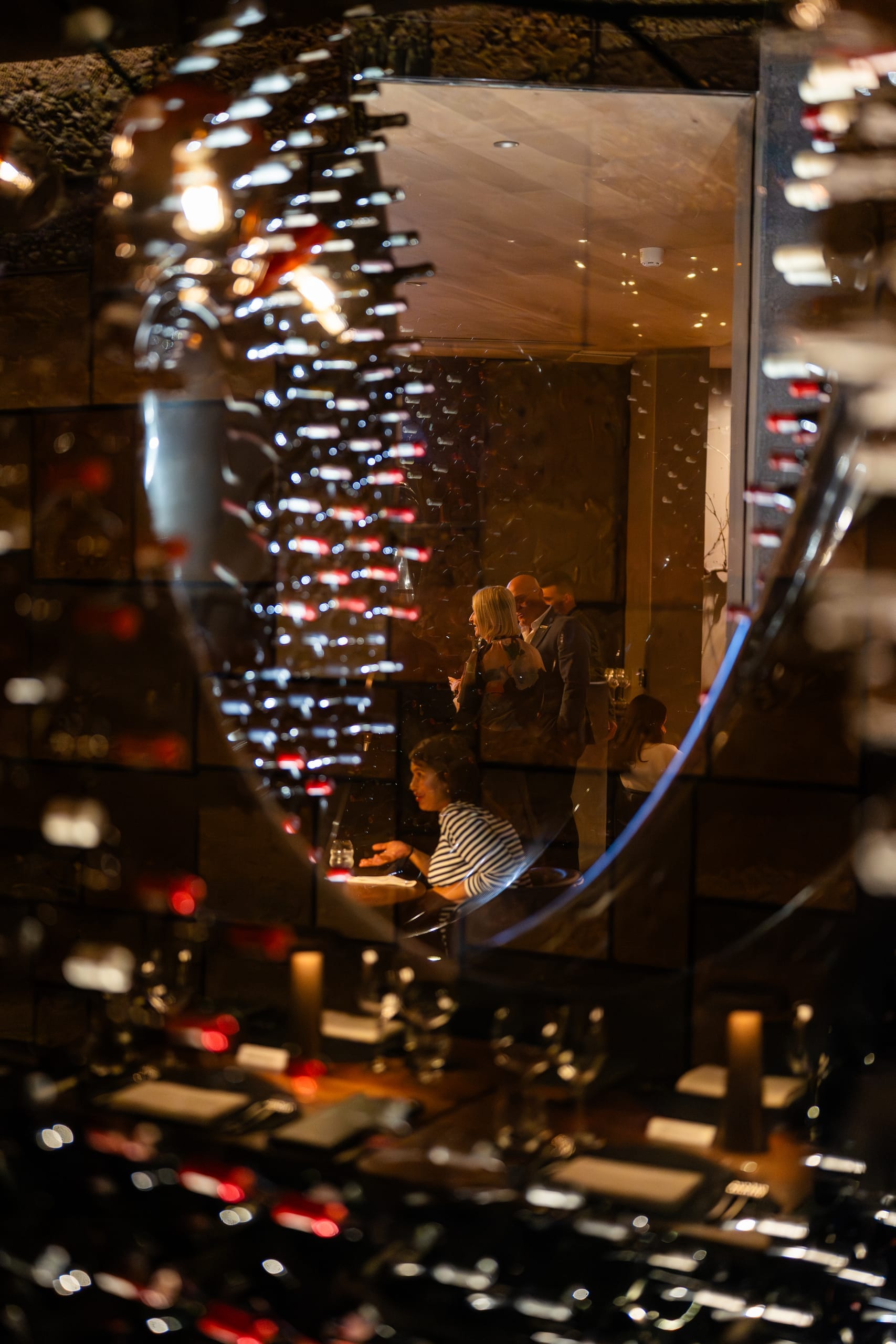A wine tasting event with glasses and bottles arranged across a long table