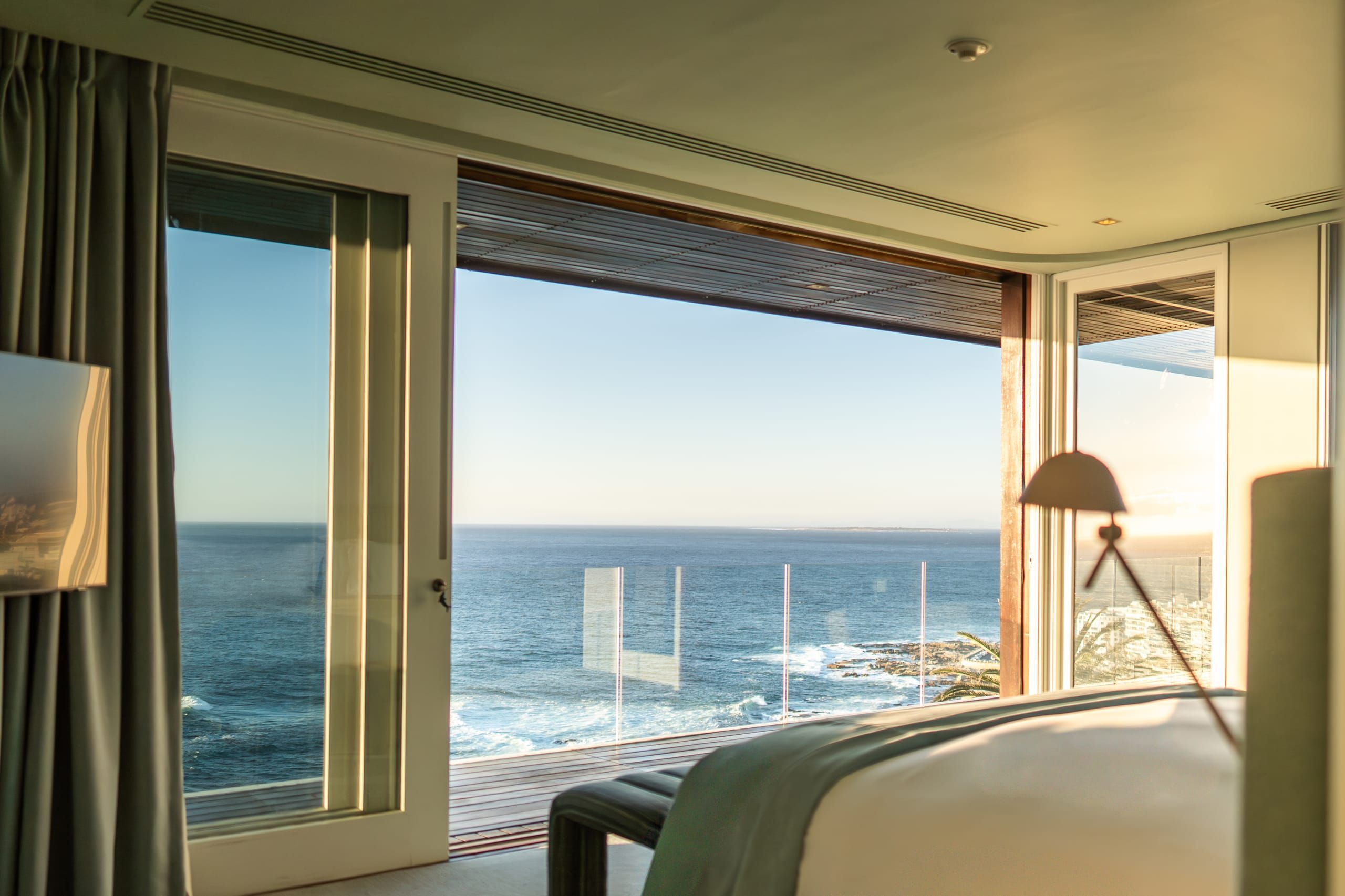An ocean-view suite filled with morning light