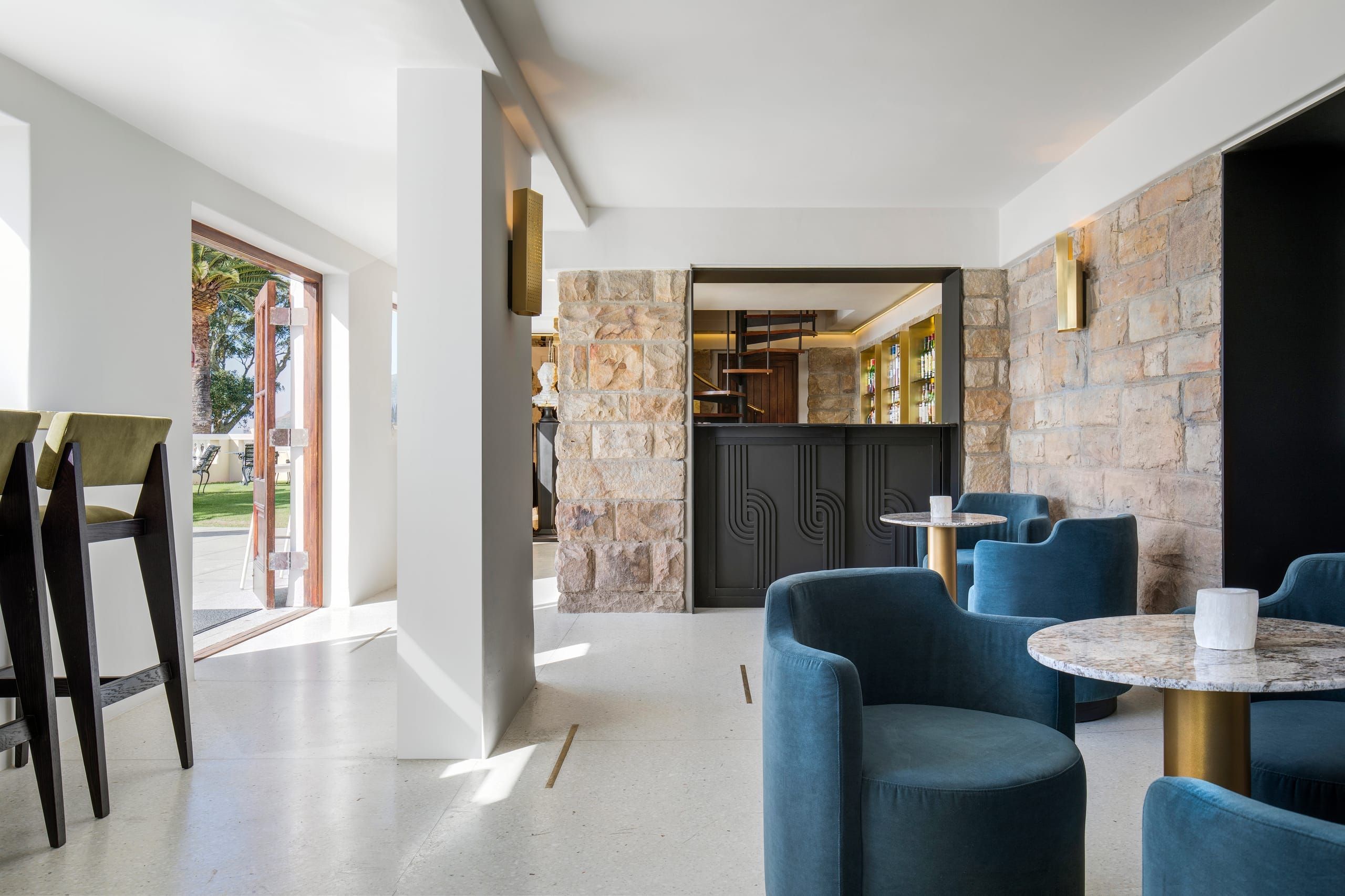 The Bar Roc lounge with green banquette seating and original South African art