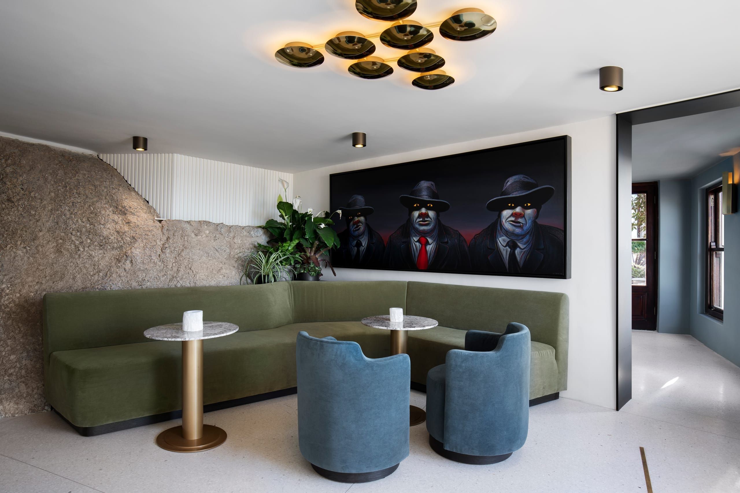 The Bar Roc lounge with green banquette seating and original South African art