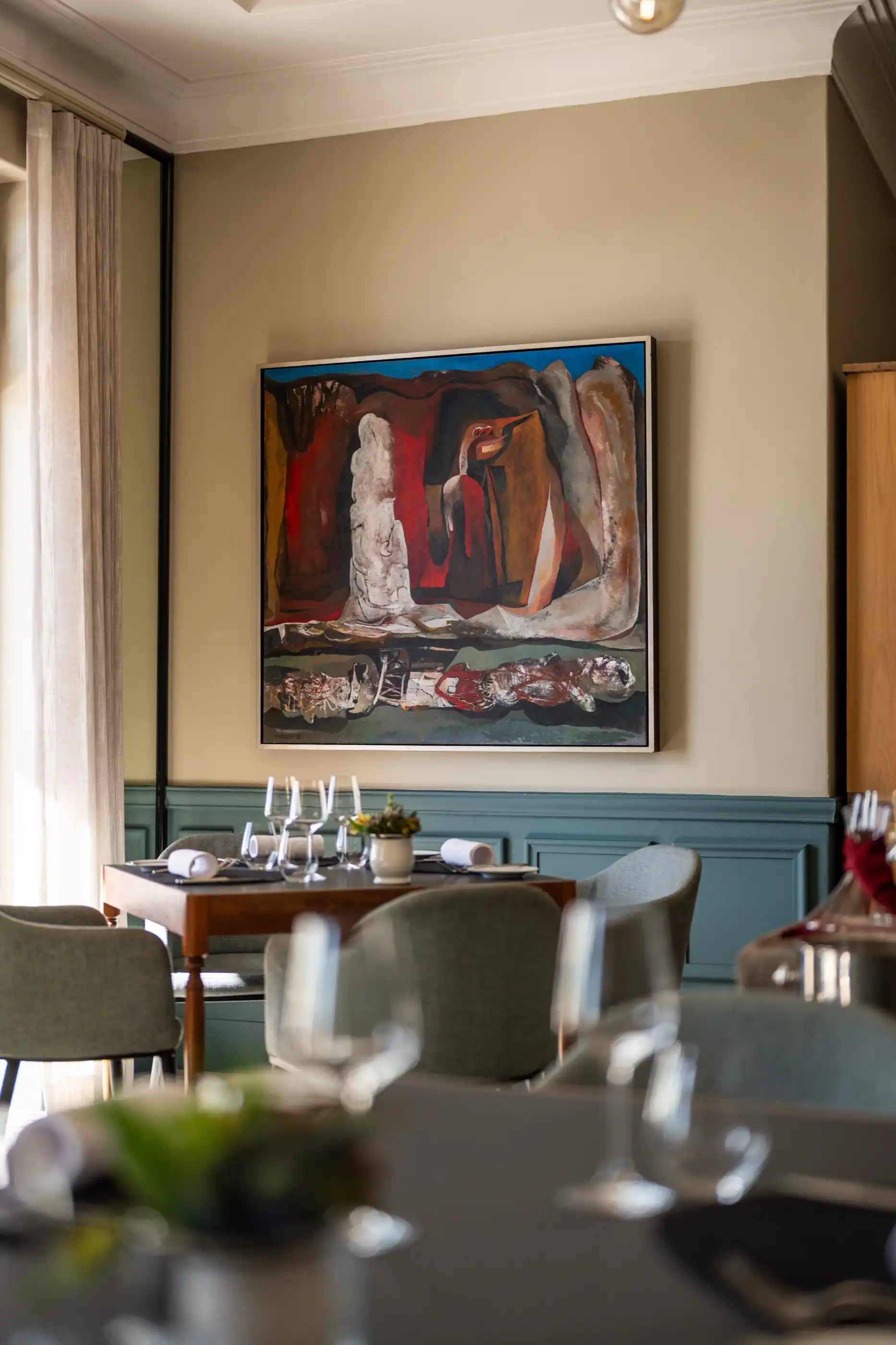An abstract painting above the dining room sideboard at Ellerman House