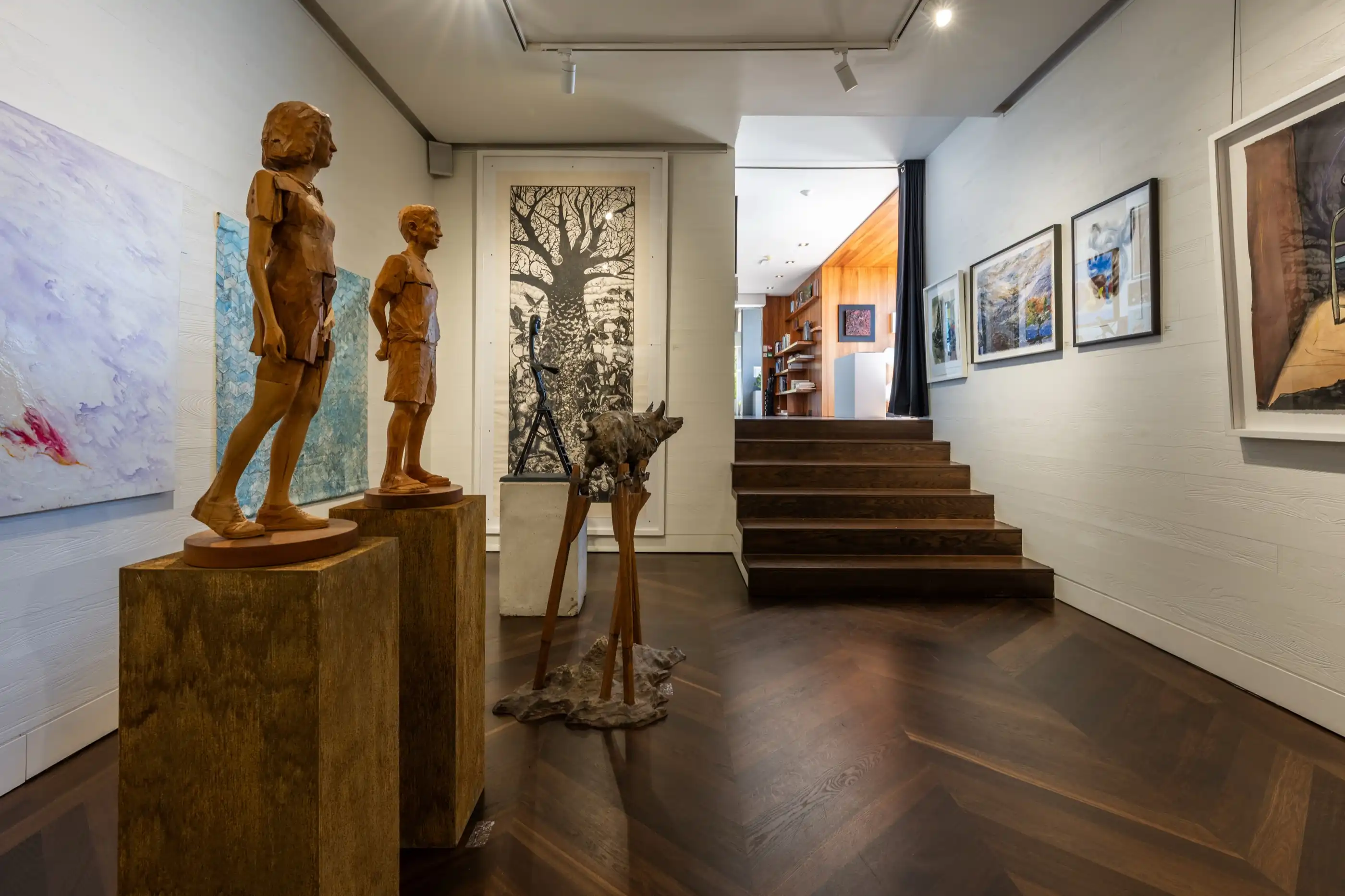 Carved wooden figures grouped on a console table