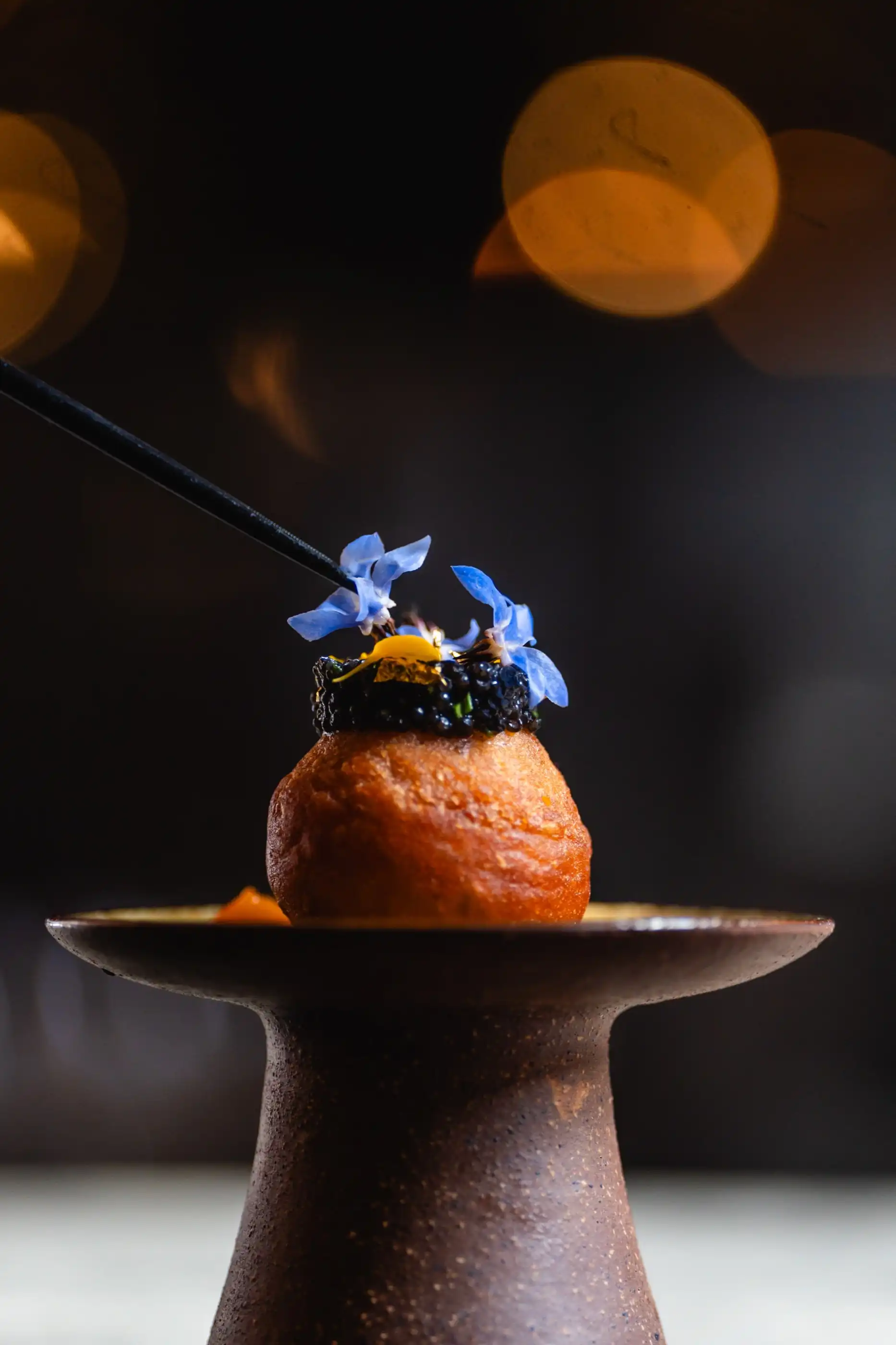 A caviar canapé finished by hand in the kitchen