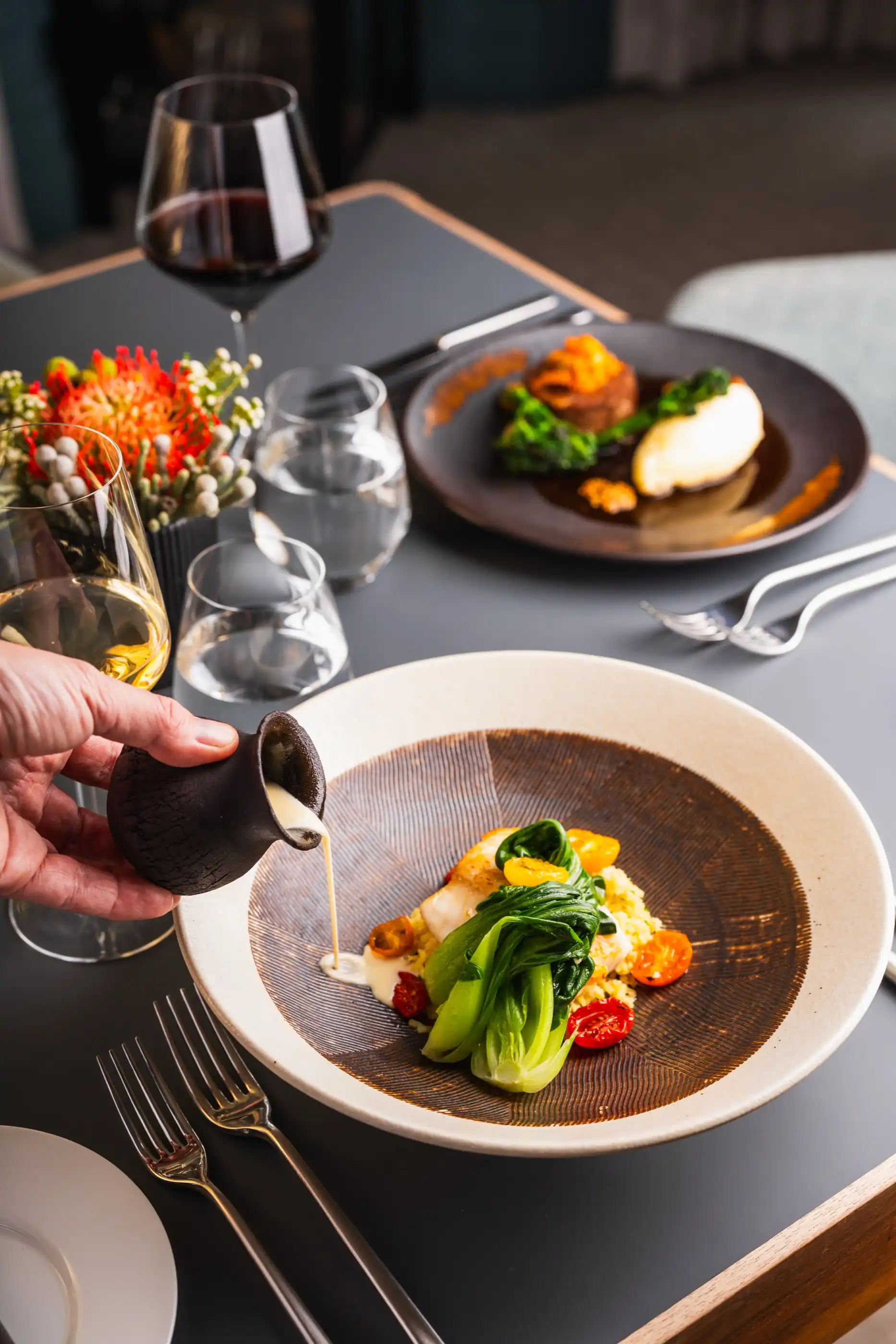 Sauce poured tableside over a plated course