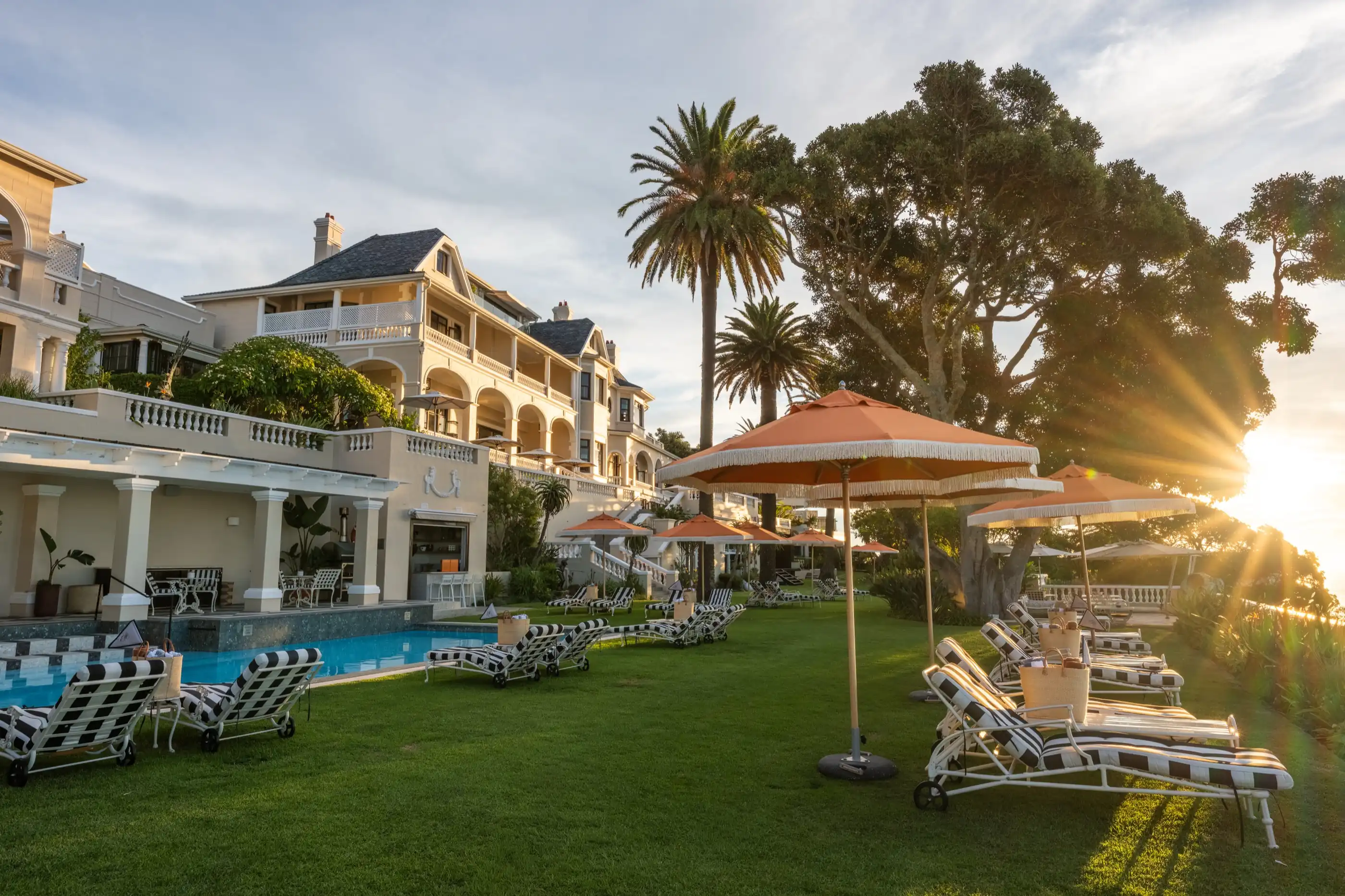 The white Cape facade of Ellerman House above its poolside garden