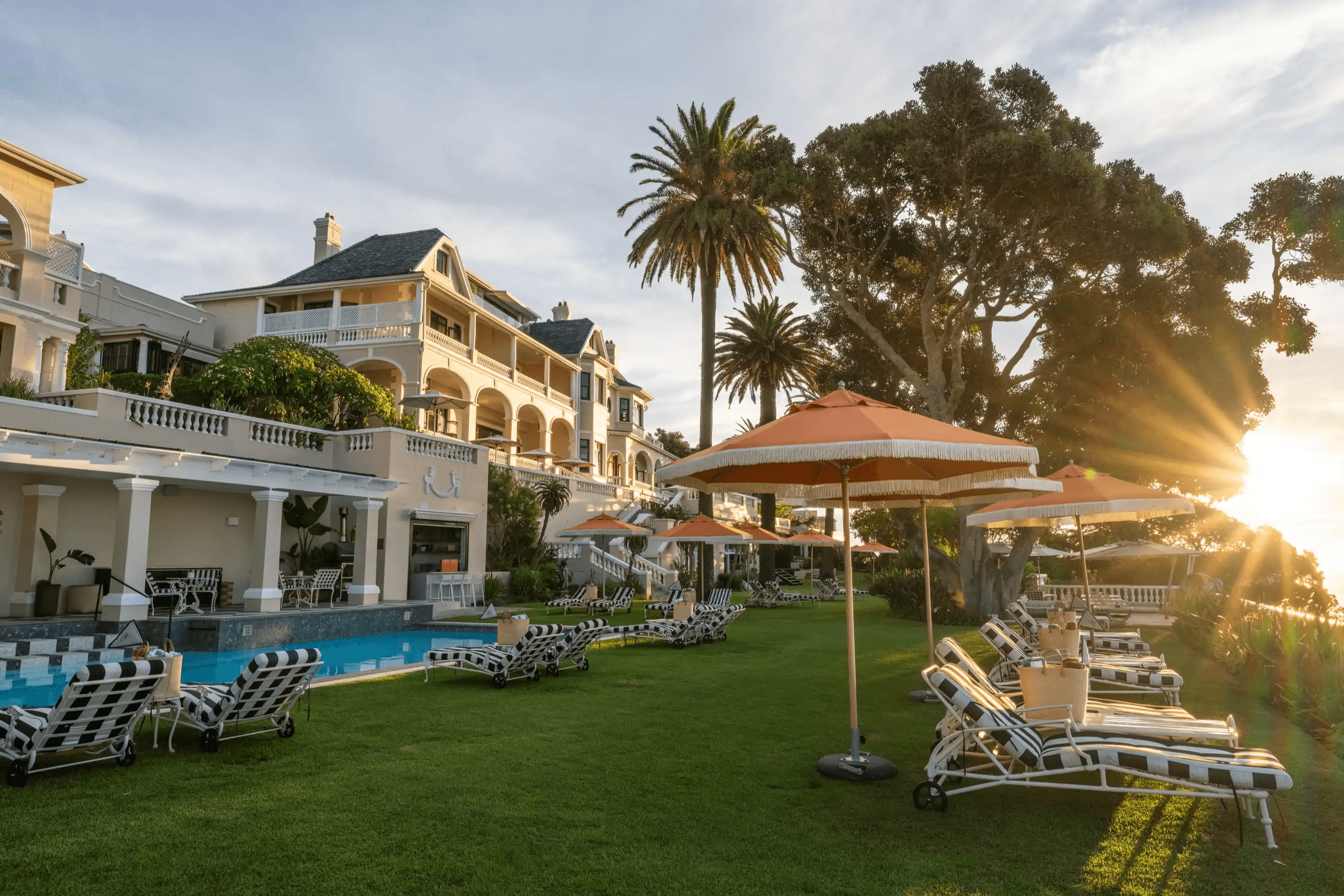 The white Cape facade of Ellerman House above its poolside garden