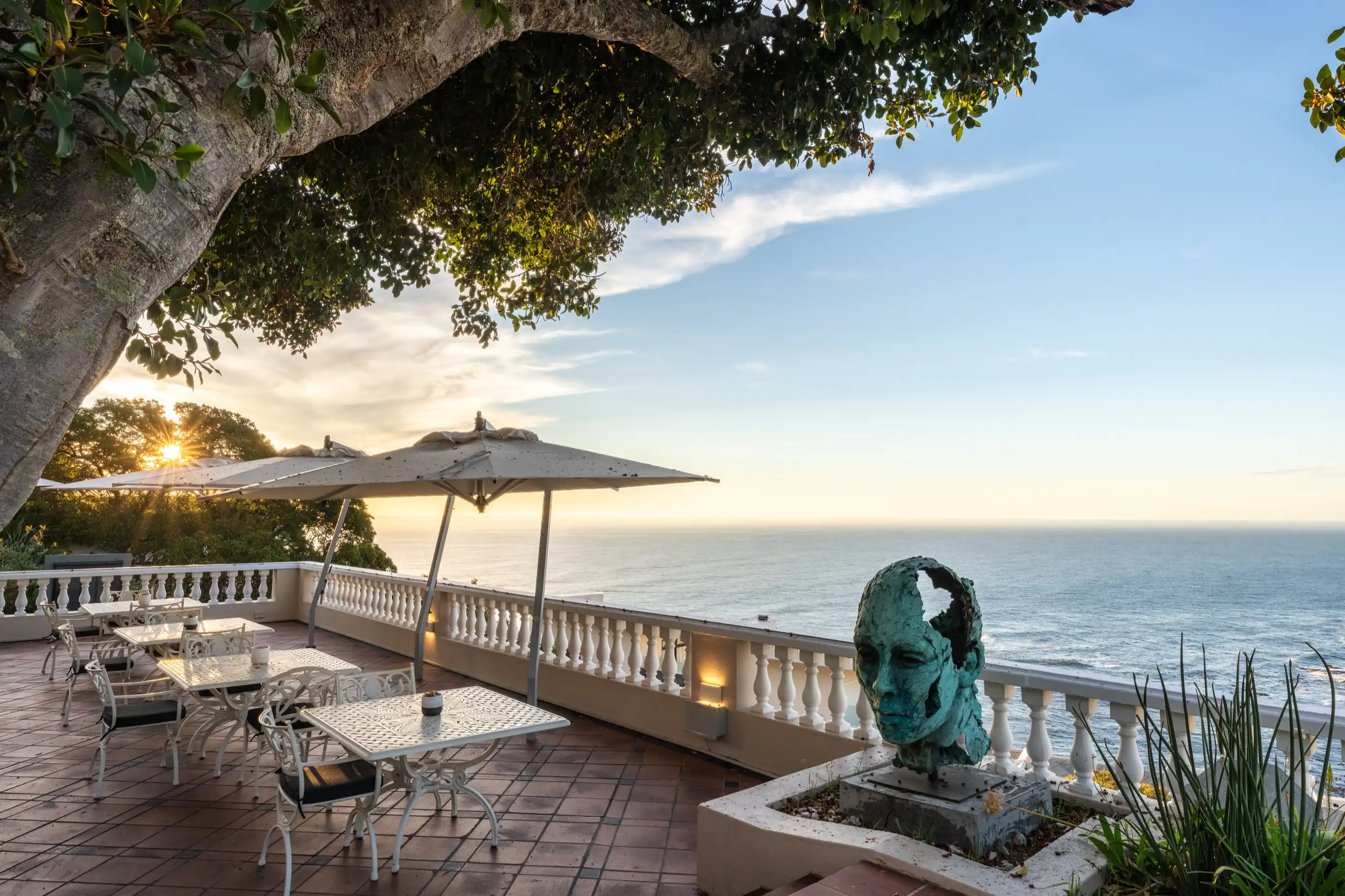 A sculpture on the ocean-view terrace above the bay