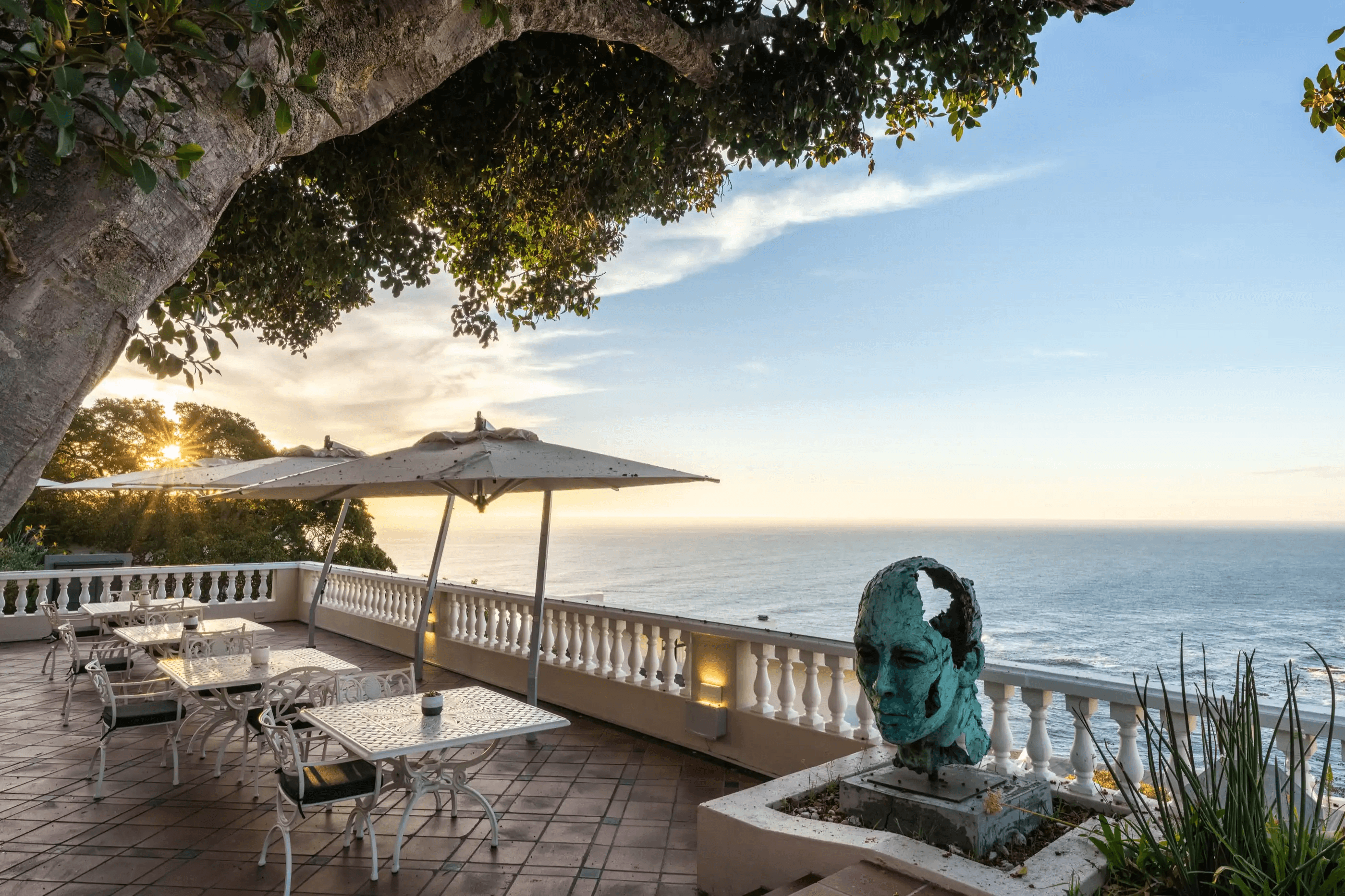A sculpture on the ocean-view terrace above the bay