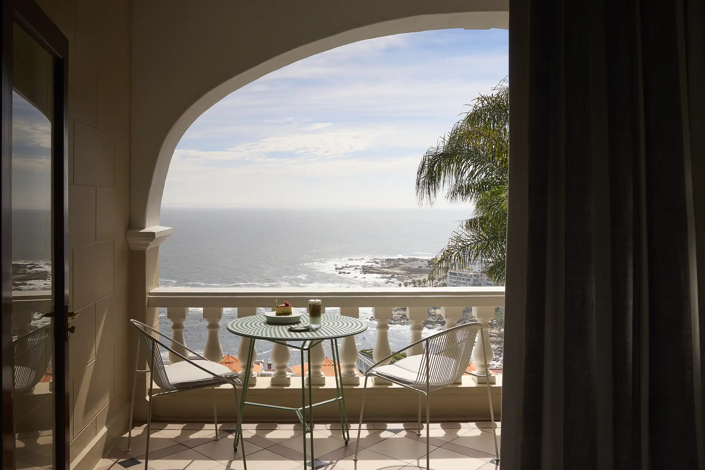 A suite balcony opening to the Atlantic at Ellerman House