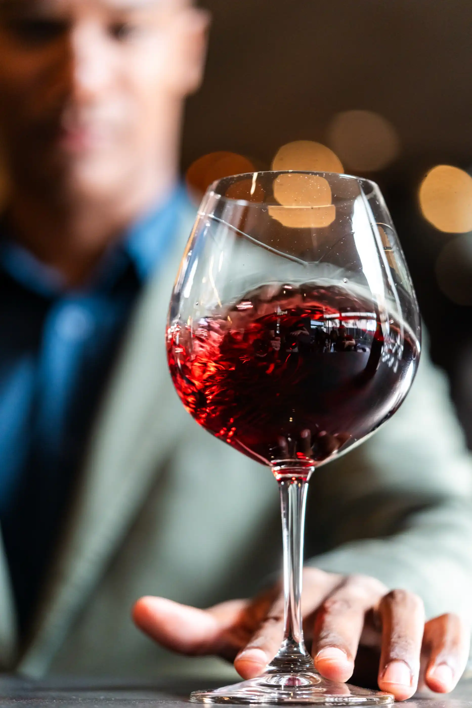 Red wine swirling in a glass under cellar light