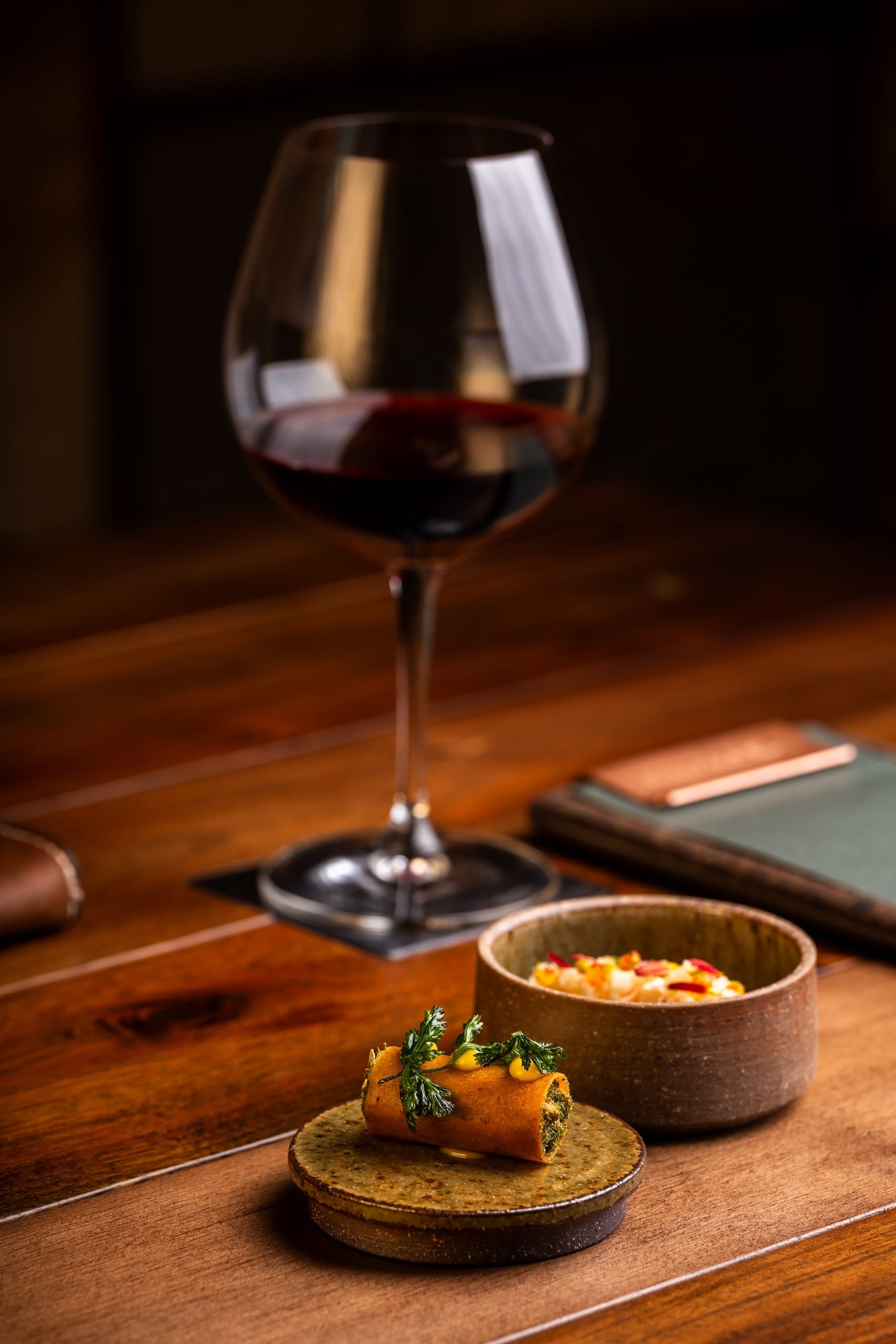 A chef carefully plating a refined seasonal course