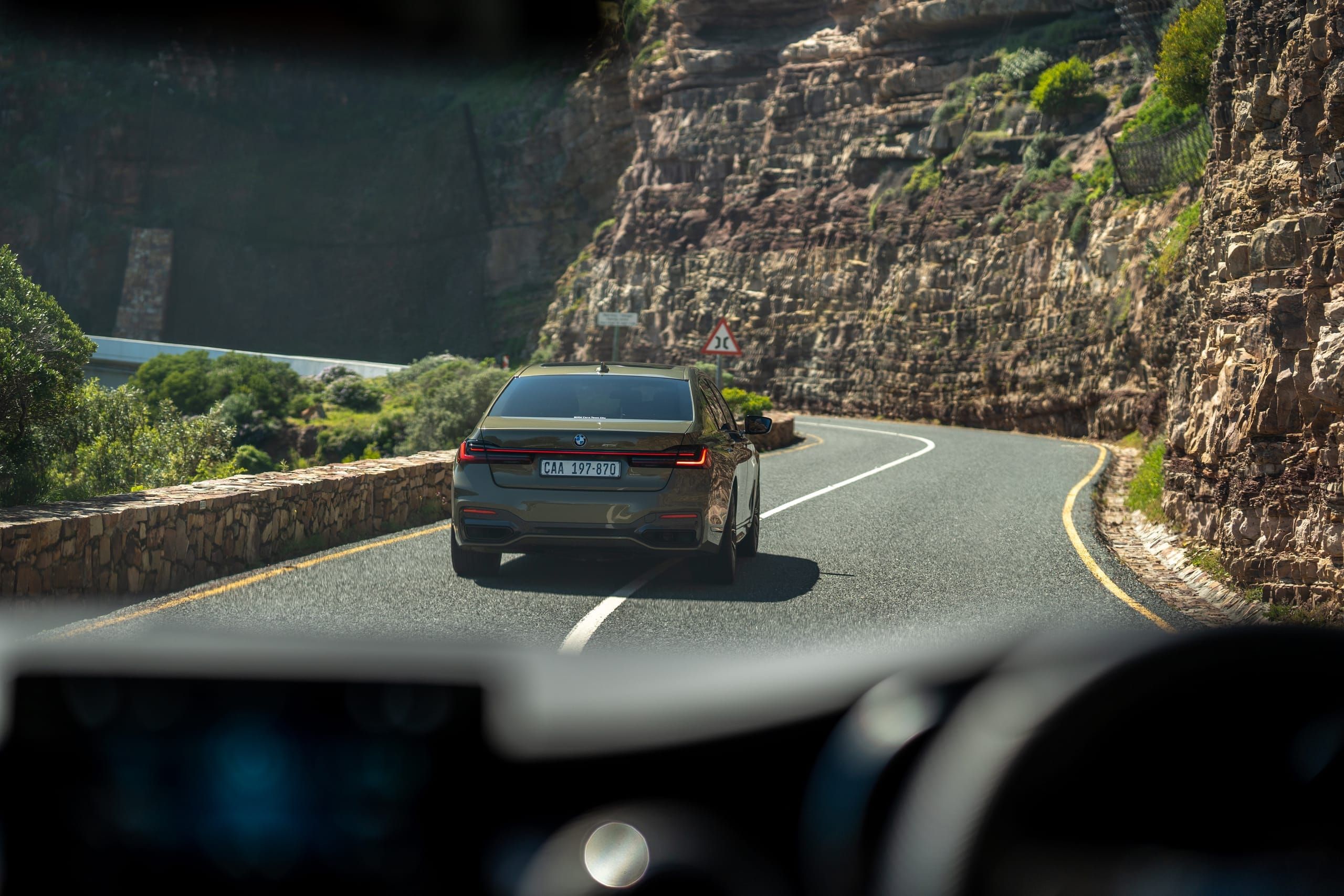 A private car following the curves of Chapman's Peak Drive