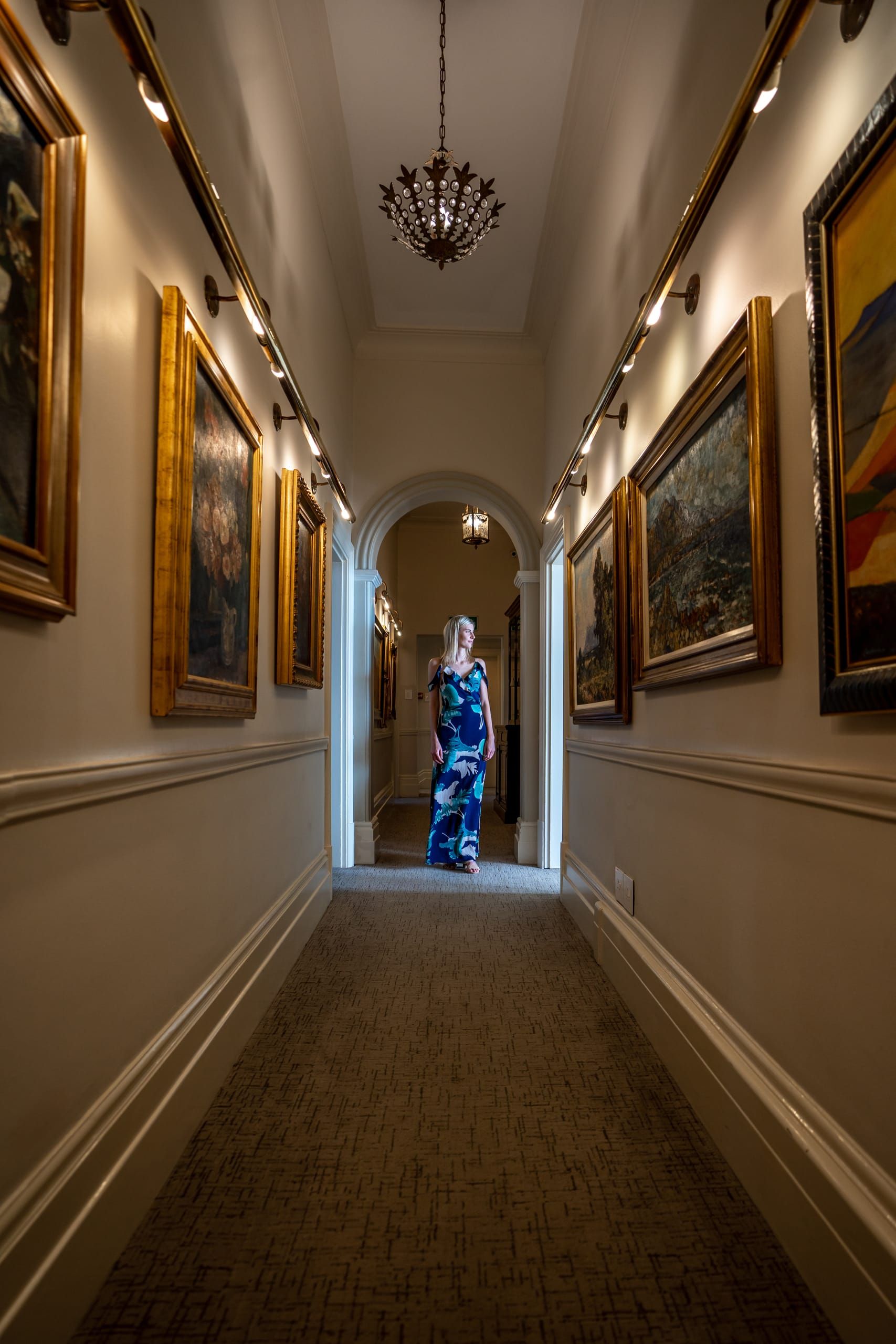 Artworks lining a hallway within the house