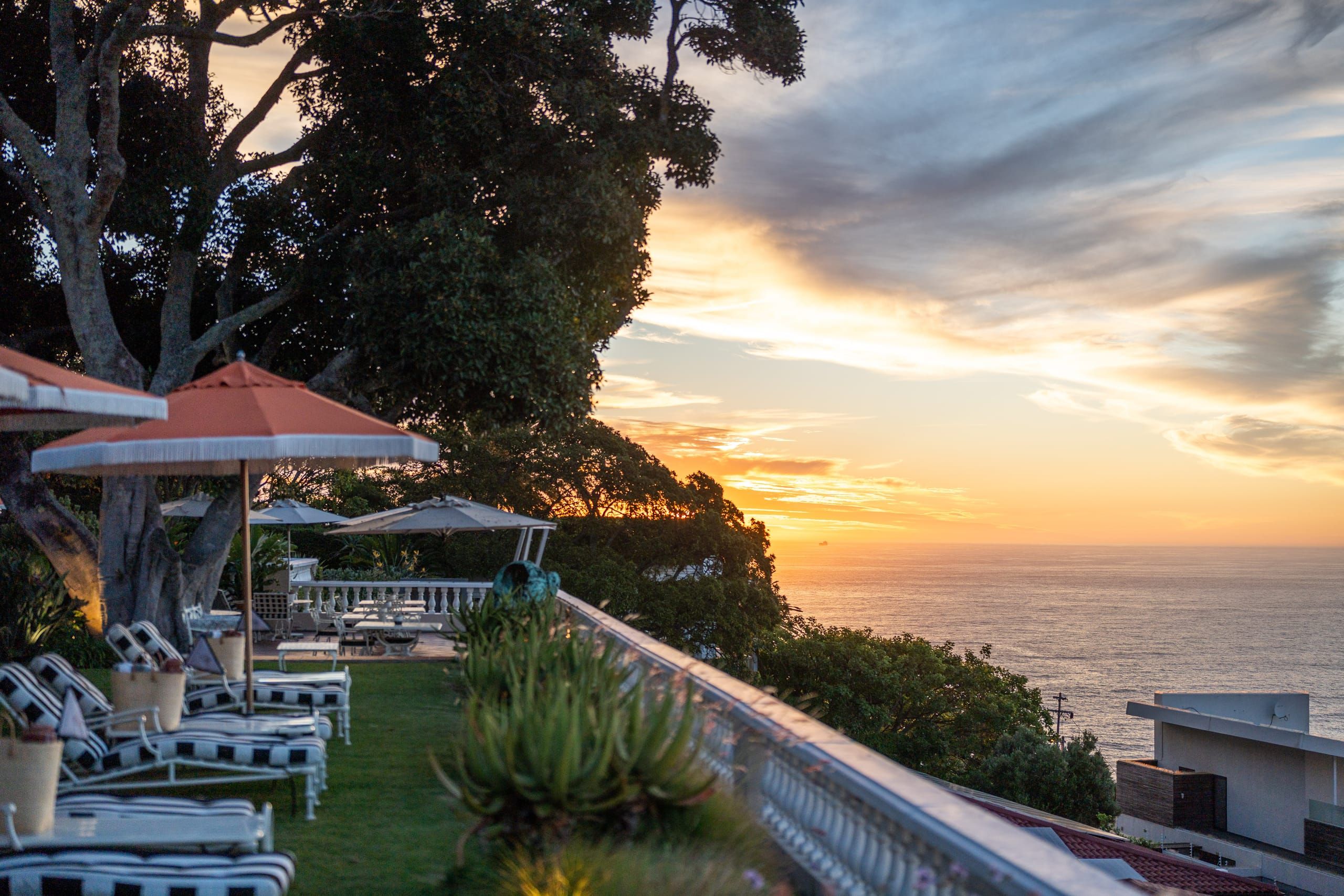 The terraces of Ellerman House opening to the Atlantic at sunset