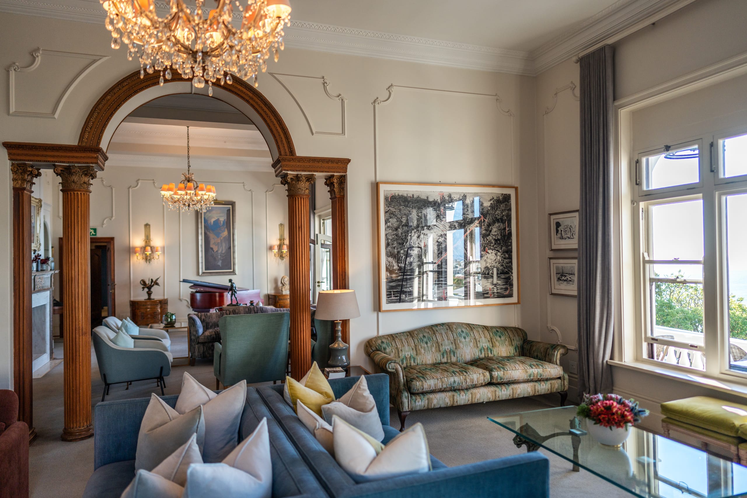 A fireside drawing room with a bay window over the gardens