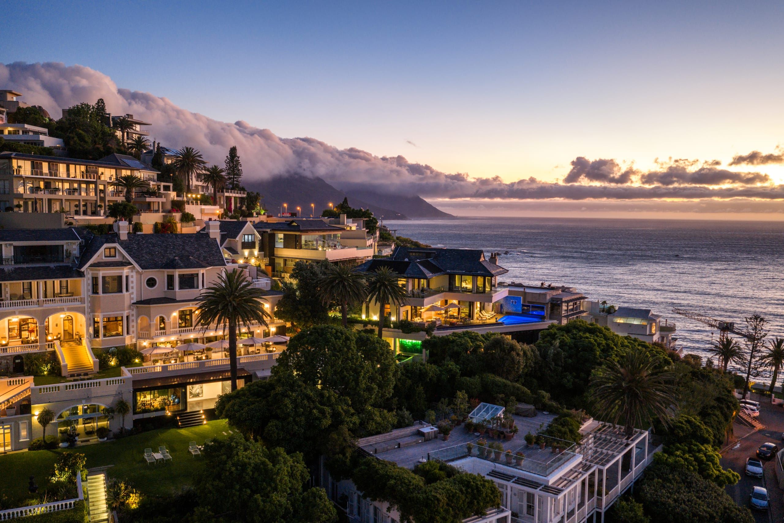 Ellerman House and its pool glowing above the Atlantic at dusk