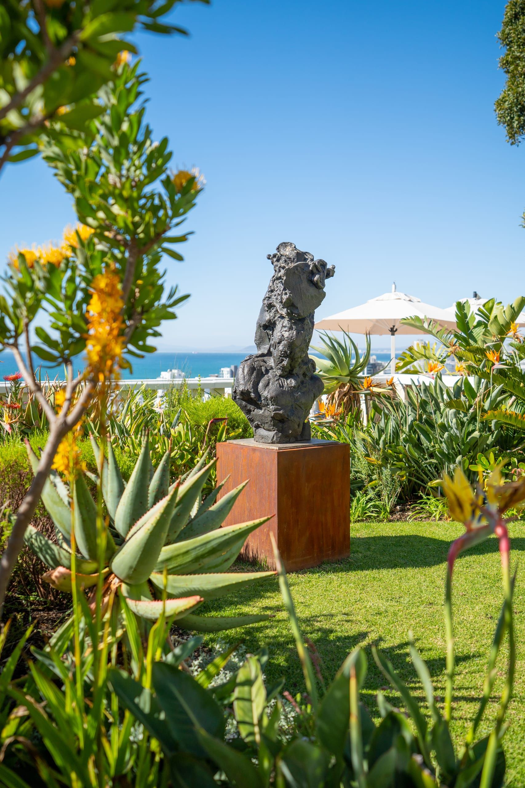 A sculpture set among the indigenous gardens above the sea
