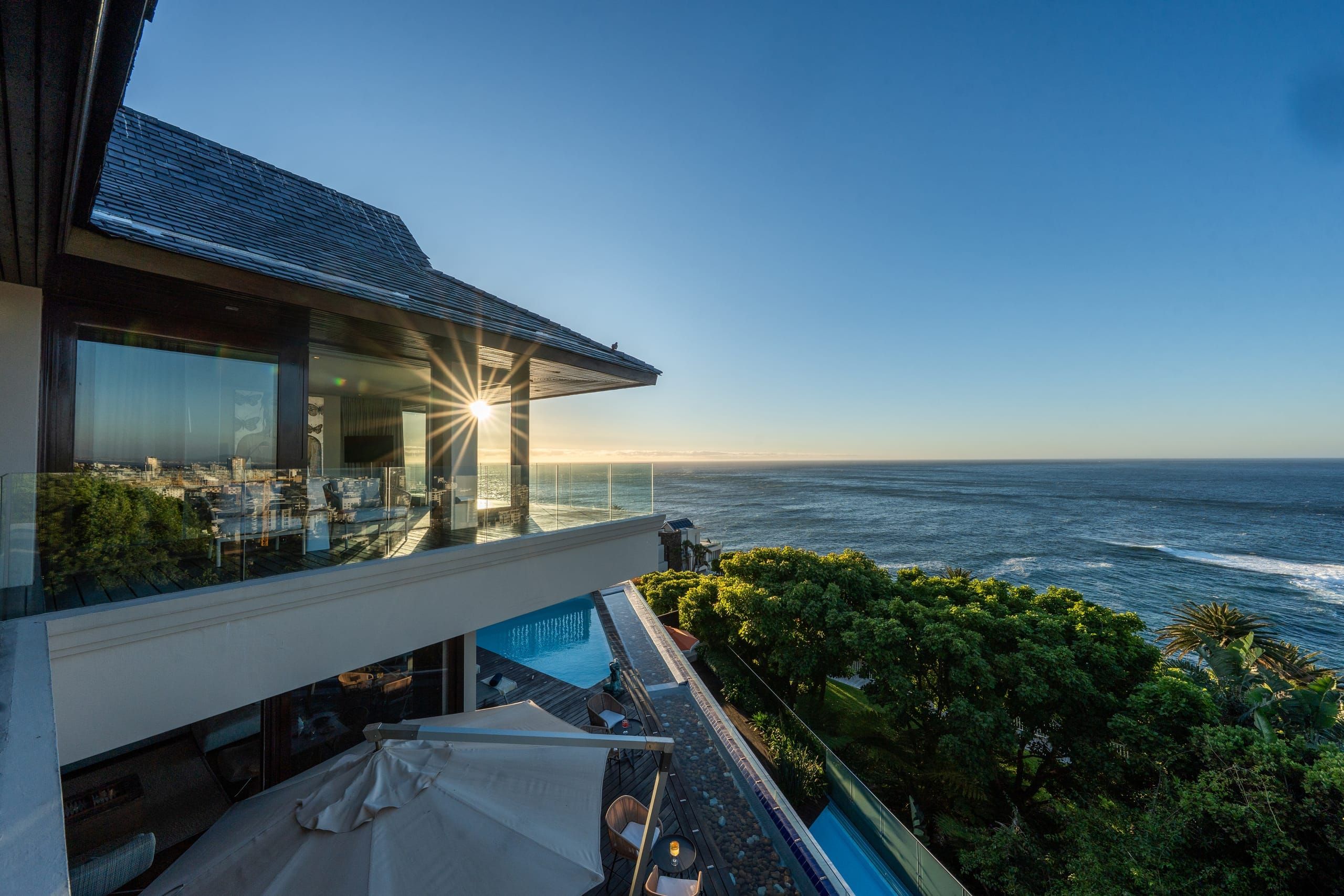 Villa exterior with infinity pool at sunset above Bantry Bay
