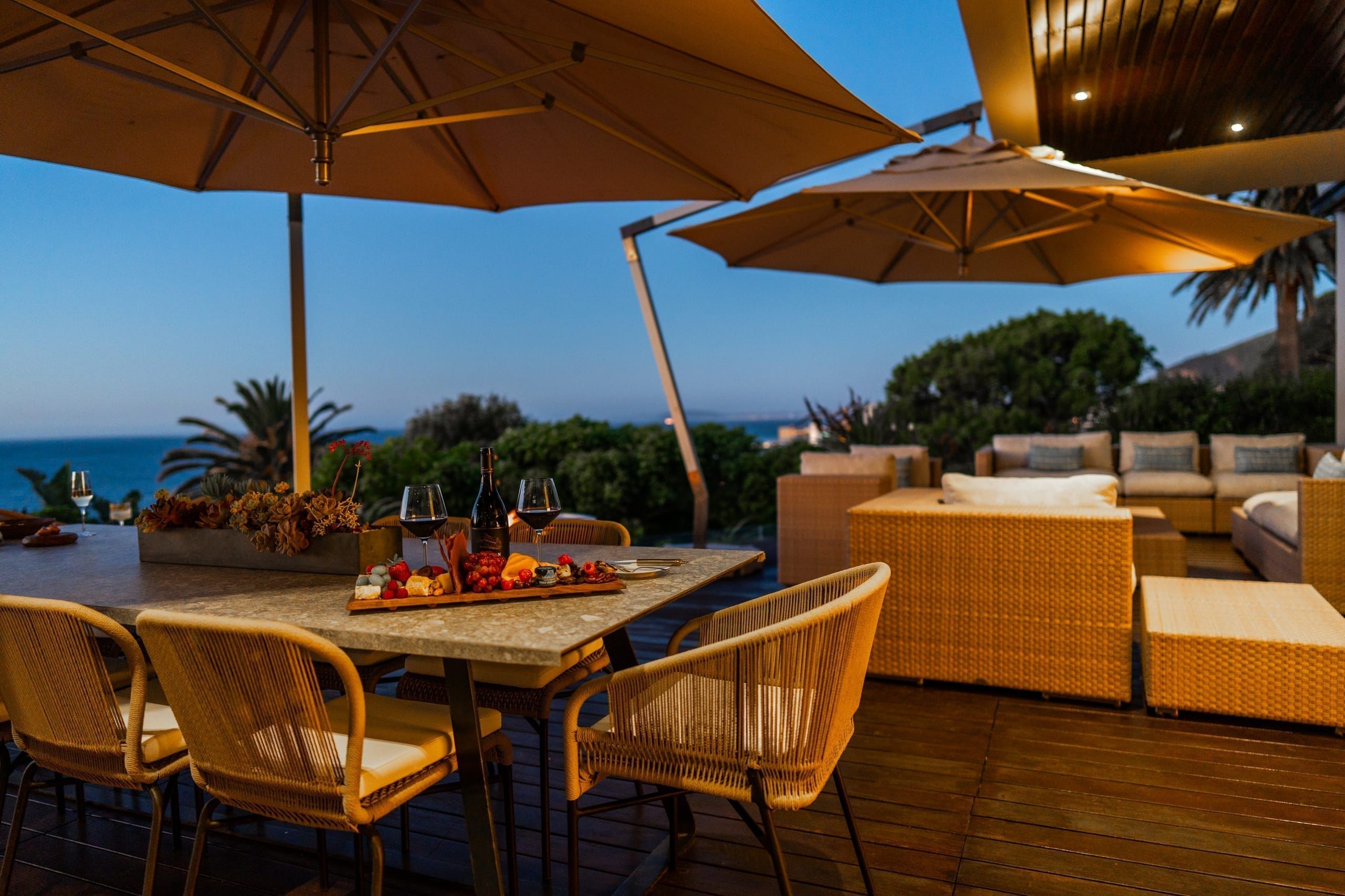 The villa by the pool at golden hour, set with wine and lunch