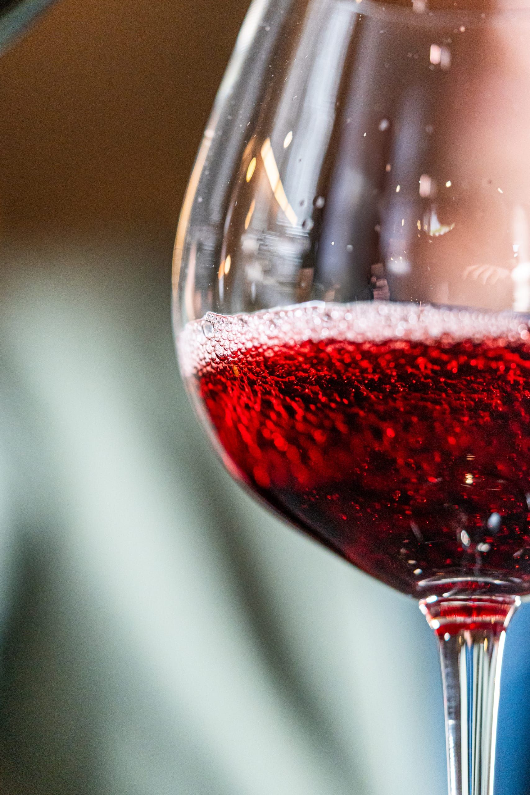 A glass of red wine swirled in the cellar