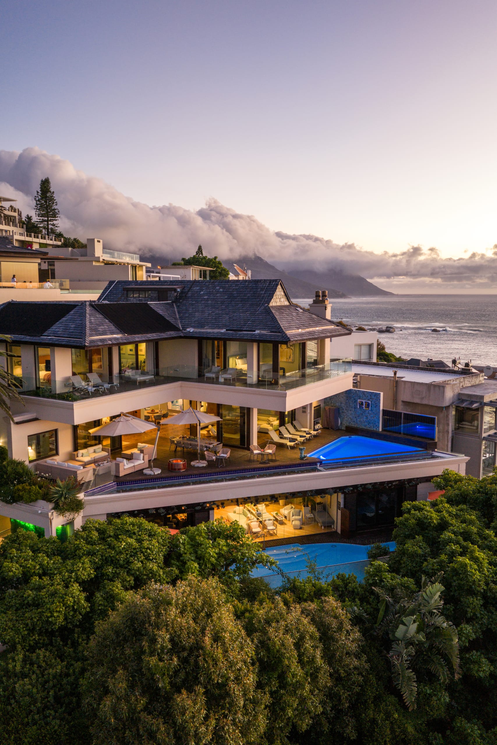Ellerman House glowing above its pool at dusk